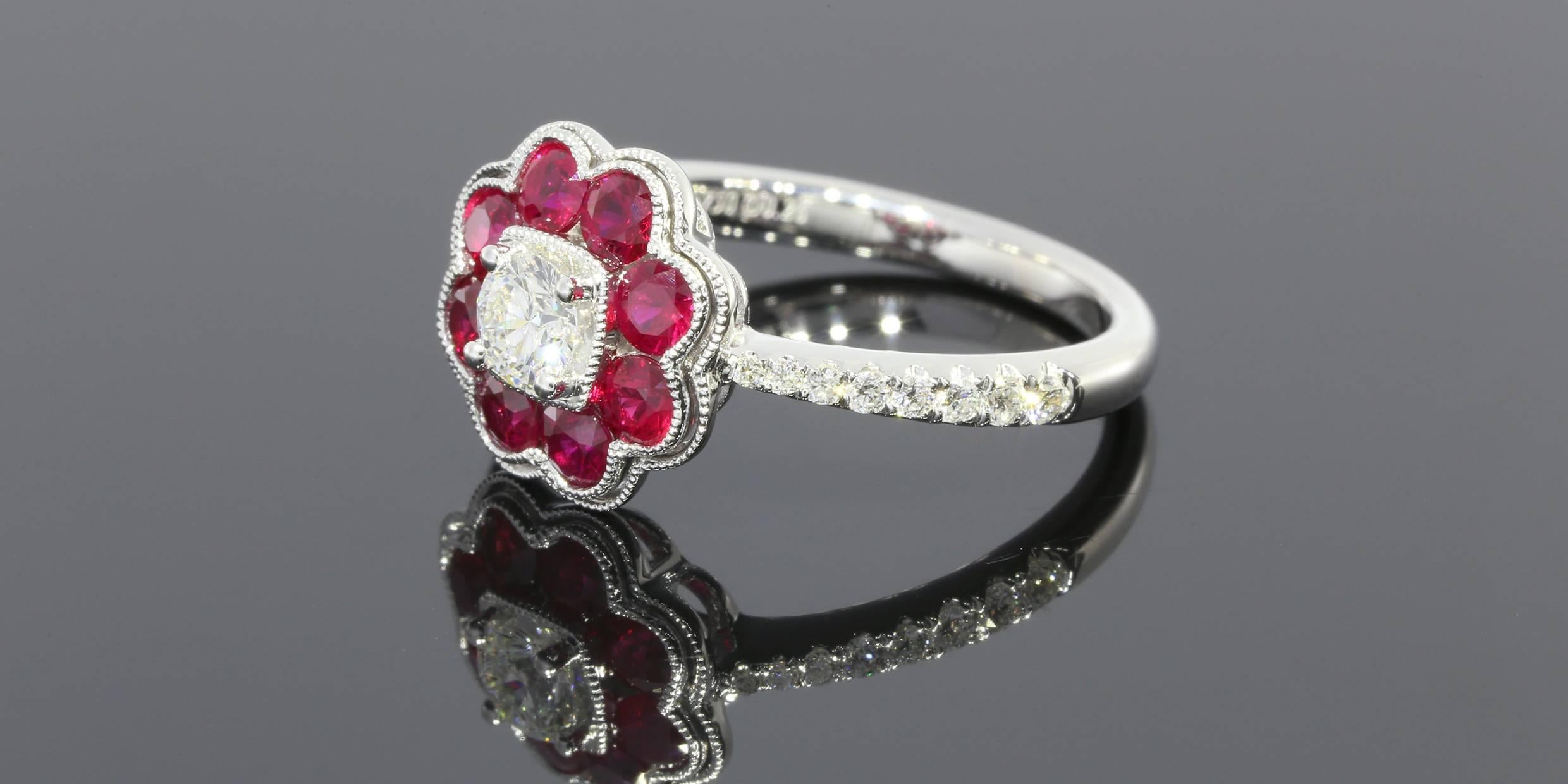 This outstanding ring features round brilliant cut white diamonds and natural rubies. The center round diamond weighs 0.26CT, 16 round accent diamonds weigh 0.21CTW and the 8 rubies weigh 0.67CTW. The total carat weight is 1.14 CTW. The ring