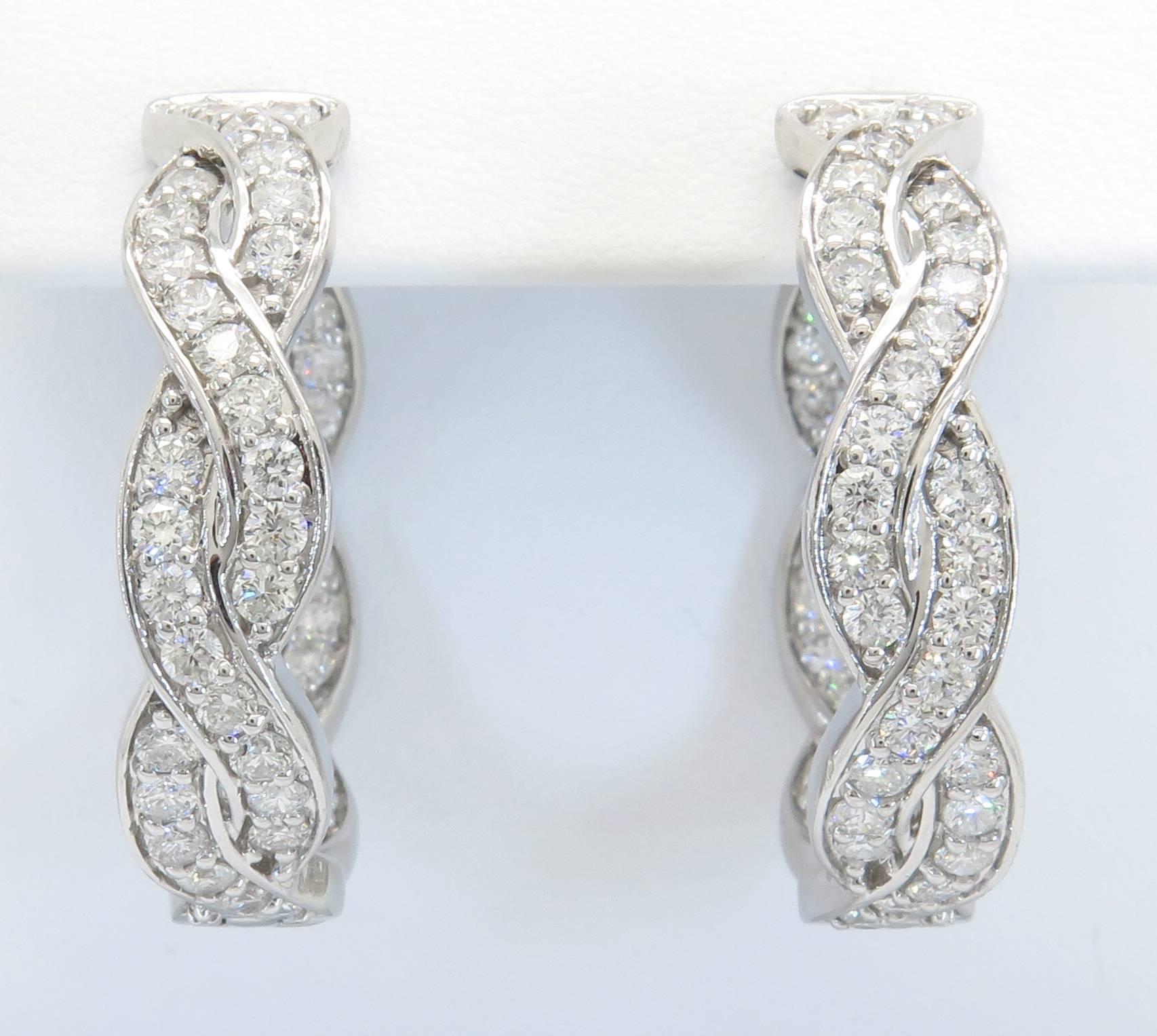 These fun diamond hoop earrings feature 112 round brilliant cut diamonds weighing in total 3.18 carats. The diamonds are G/H in color and SI1 in clarity, meaning bright white and completely eye clean. The diamonds are prong/bead-bright set in a