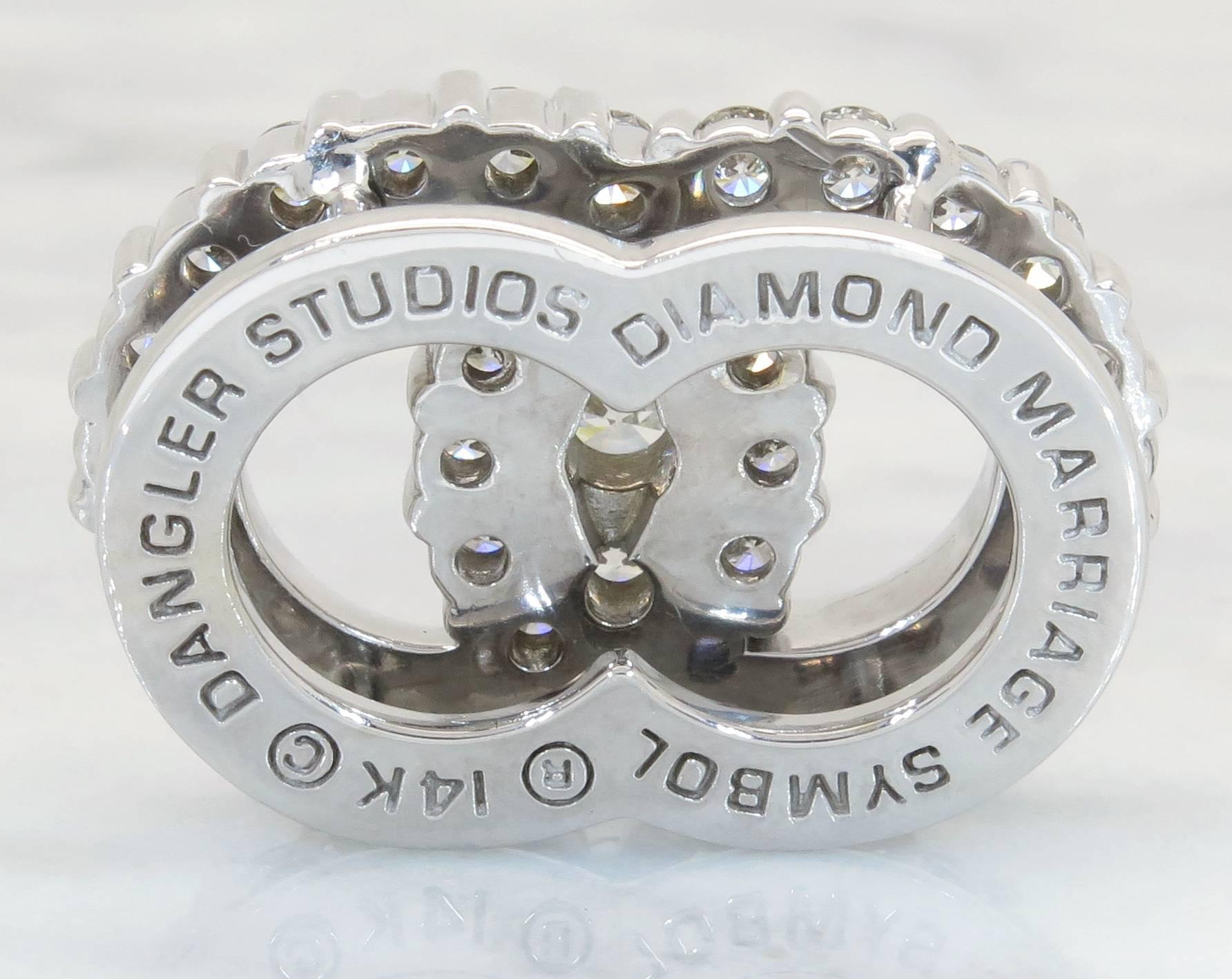 This beautiful pendant features 35 round brilliant cut diamonds weighing 3.16 carats in total. The diamonds are G-I in color and SI1 in clarity. The diamonds are prong set to form two unified circles, to symbolize marriage. The pendant is comprised