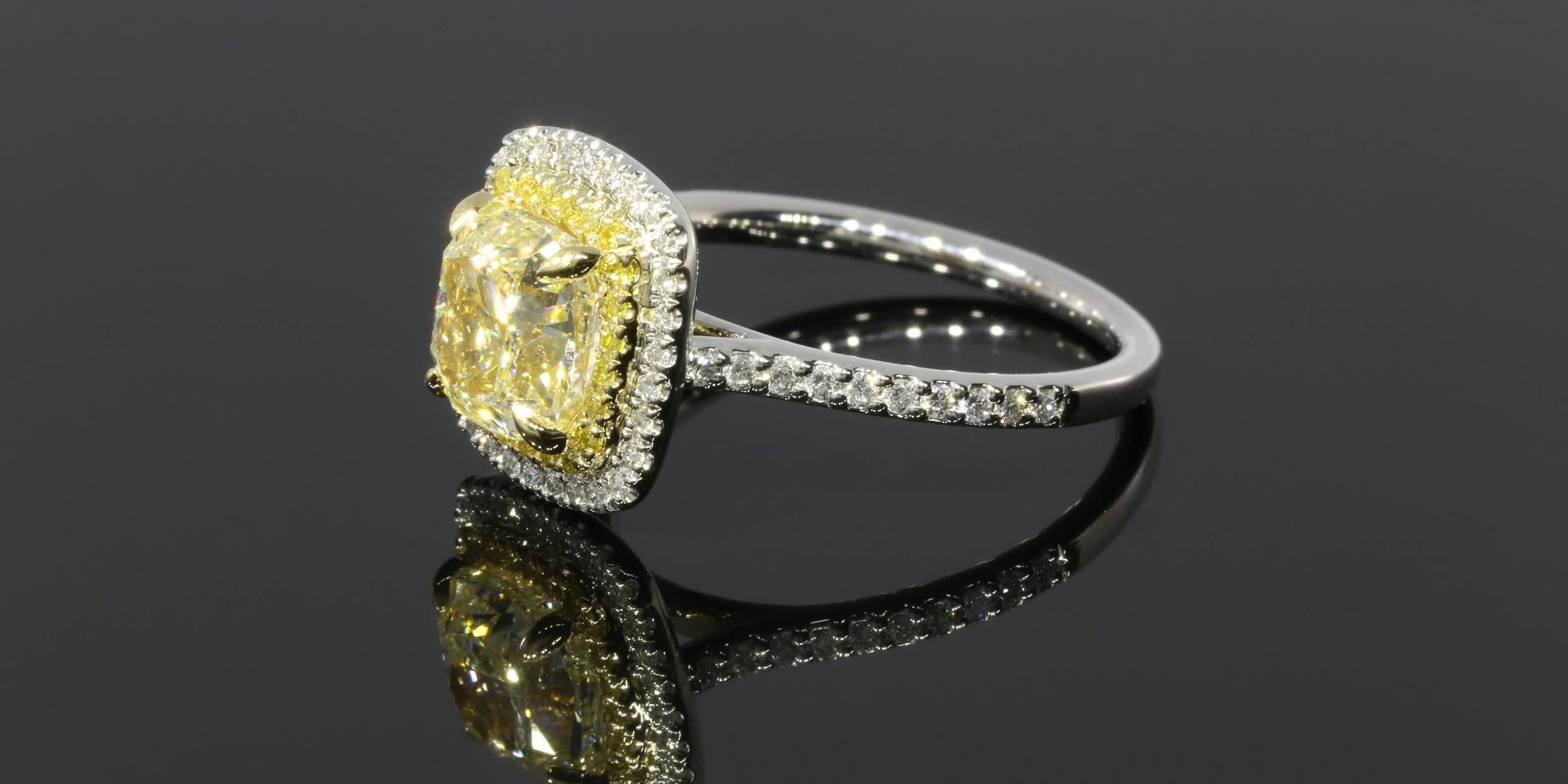 Canary diamonds have a beautiful warmth that sparkle like sunshine. They are a unique alternative to the traditional white diamond engagement ring. The center diamond is a 2.02CT natural fancy light yellow cushion cut diamond with a SI2 clarity. It