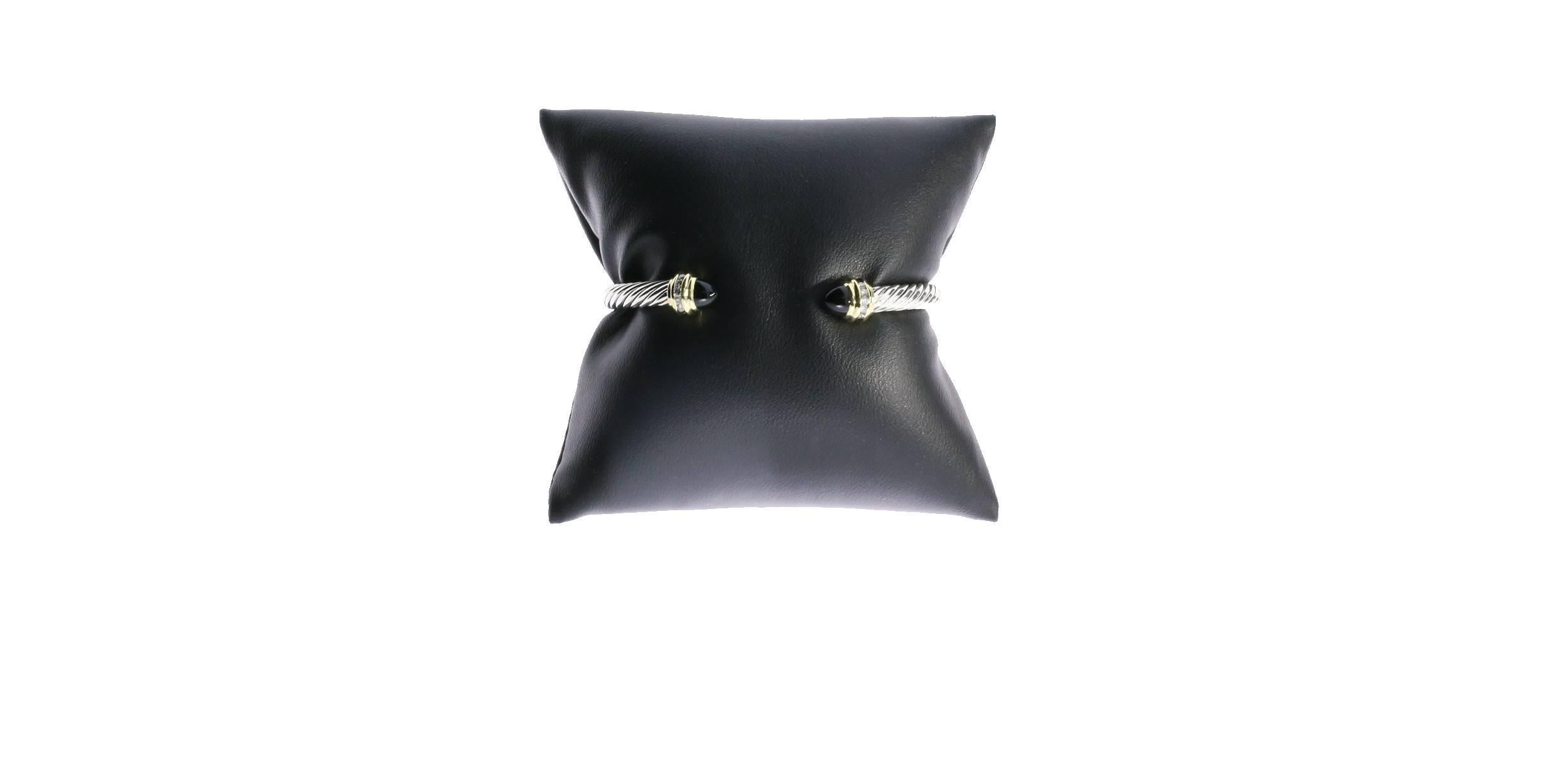 David Yurman's cable style jewelry has become his signature, the unifying element of every collection. This beautiful Cable Classics Collection bracelet is 5mm wide and has cabachon black onyx end caps. Brilliant diamonds totaling .18 carat adorn