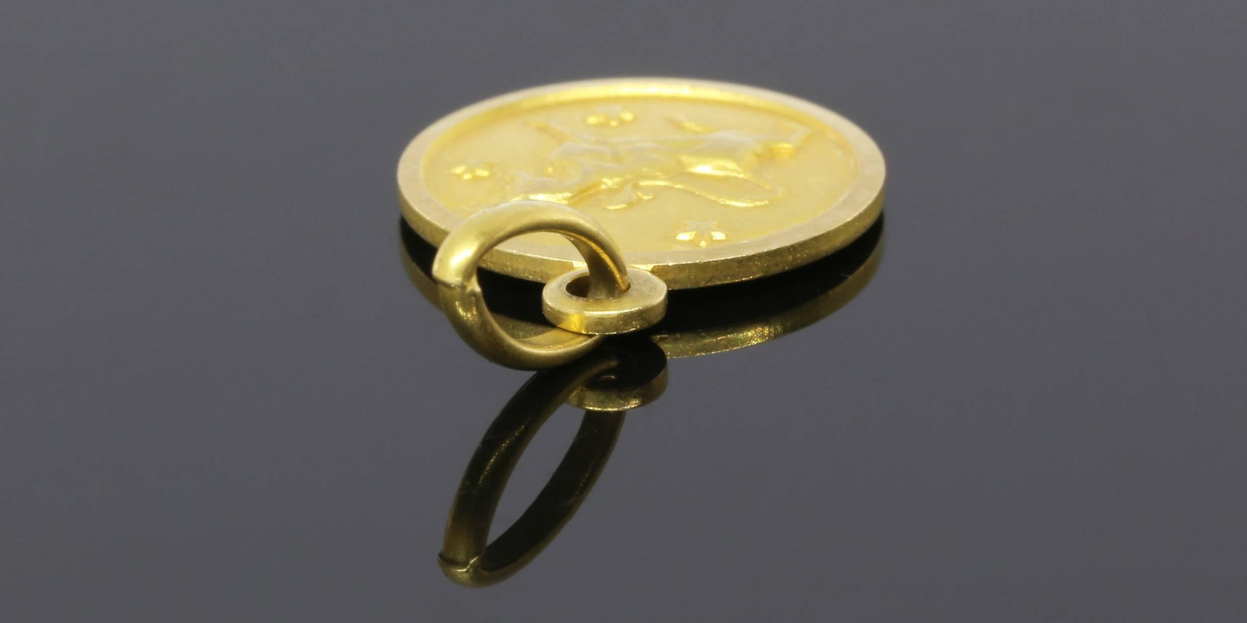 This small, 18 karat yellow gold, round charm features a powerful & proud bull with a matte finish & stars in the background. The bull is the Zodiac symbol for Taurus (April 20 - May 20). The charm measures approximately 20 millimeters in length