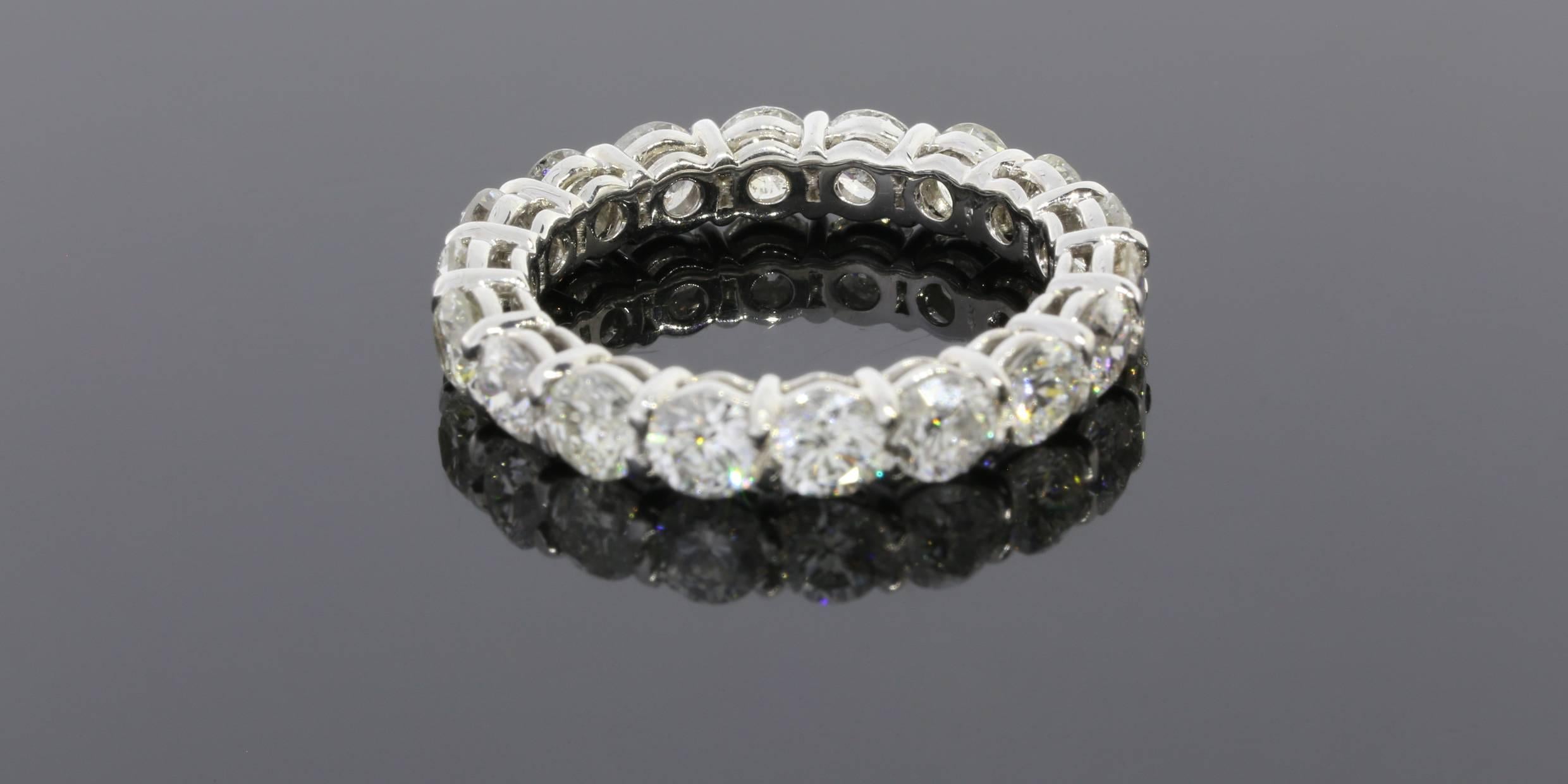 This classic band is a beautiful 18 karat white gold diamond eternity band that can dress up any ring. It can be used as a wedding band, stand alone band, or stack ring. The ring has 18 round brilliant cut diamonds that have a combined total weight