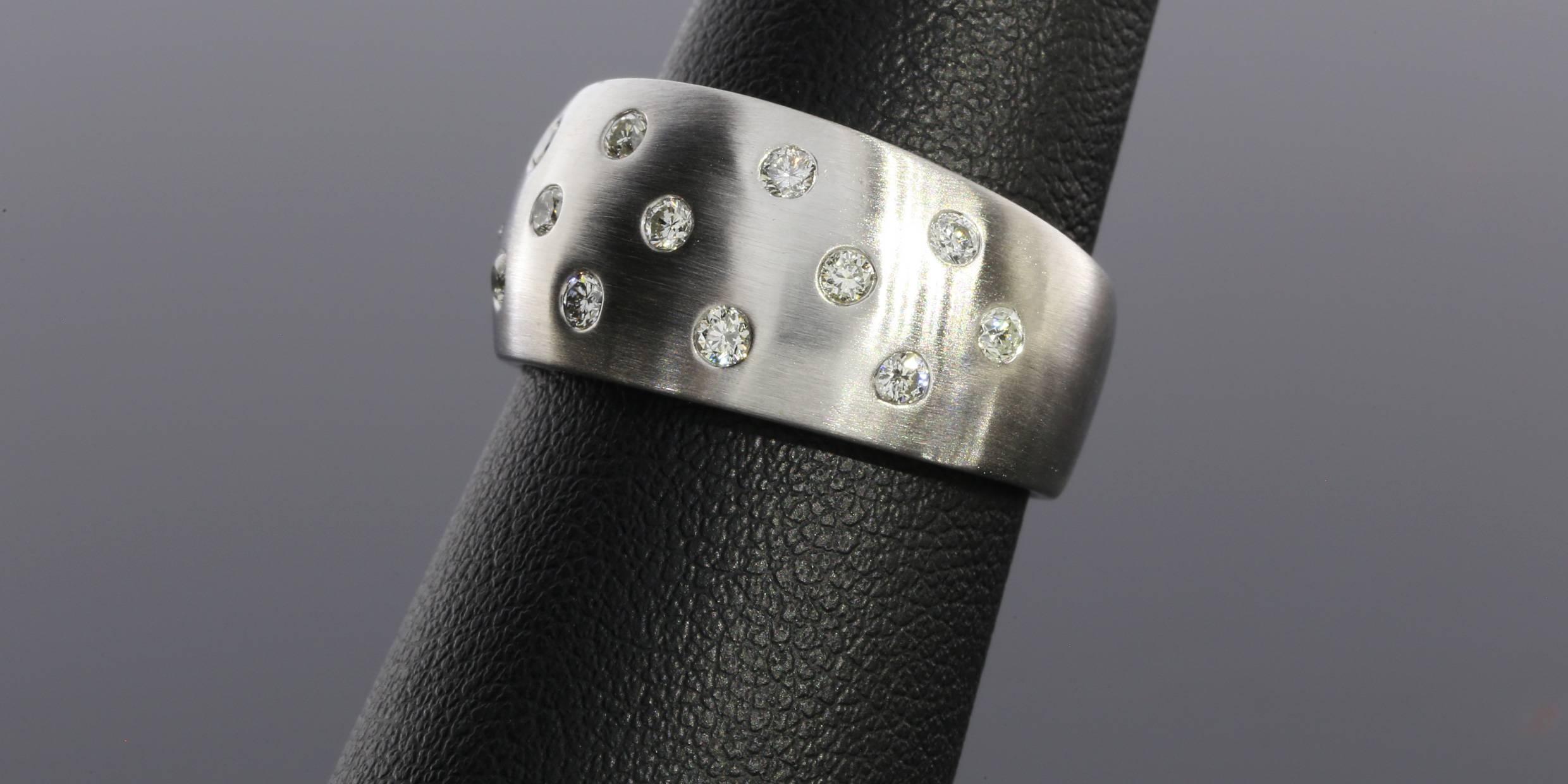 This classic band is a beautiful 14 karat white gold flush set diamond band. Flush setting is perfect for someone who wants a little sparkle, but no prongs or anything sticking up that could catch. This beautiful ring features round brilliant cut