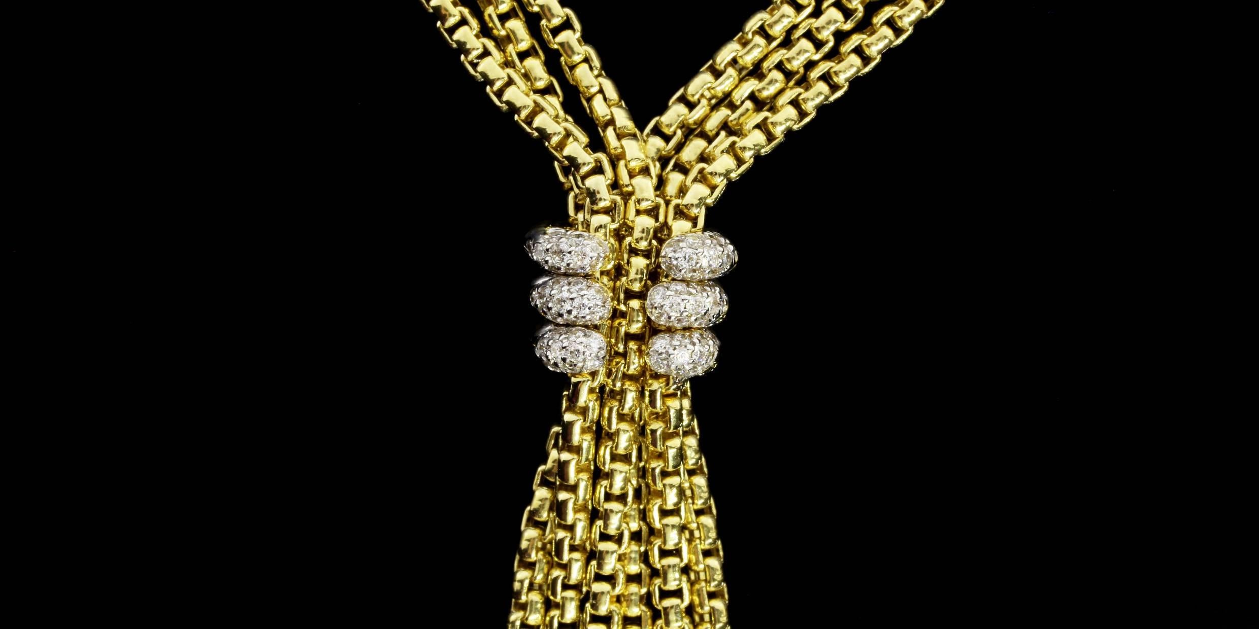 This is a beautiful statement necklace from David Yurman in classic 18 karat yellow gold. It features 3 strands of yellow gold box chain that come together in the center to form a tassel with a pave diamond station & pendulum like ends. The necklace