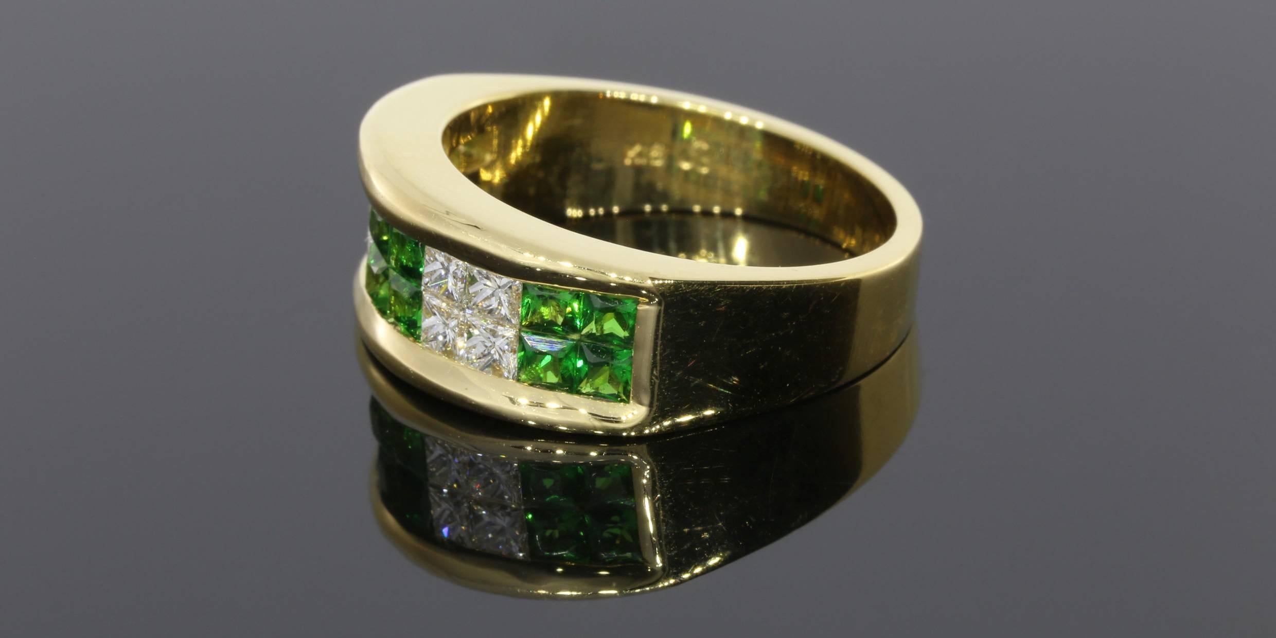 This gorgeous & unique band features princess cut tsavorite garnets that have a wonderfully vibrant green color. It also features top quality, princess cut diamonds. These stones are channel & illusion set in 2 rows across an 18 karat yellow gold