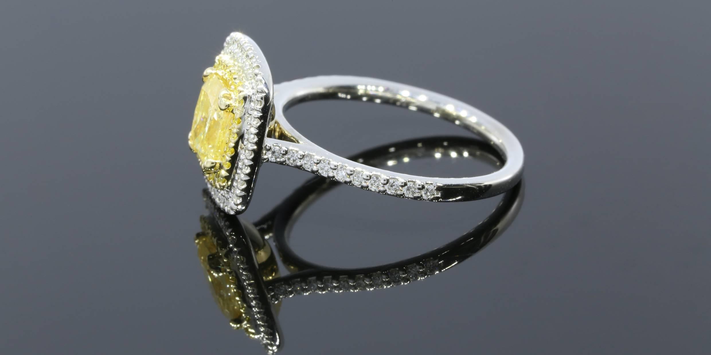 This gorgeous halo engagement ring features an absolutely stunning 1.12 carat fancy yellow, cushion brilliant cut center diamond that is set in a yellow gold, split prong head. This center diamond has a GIA Color Diamond Certification & grades as I1