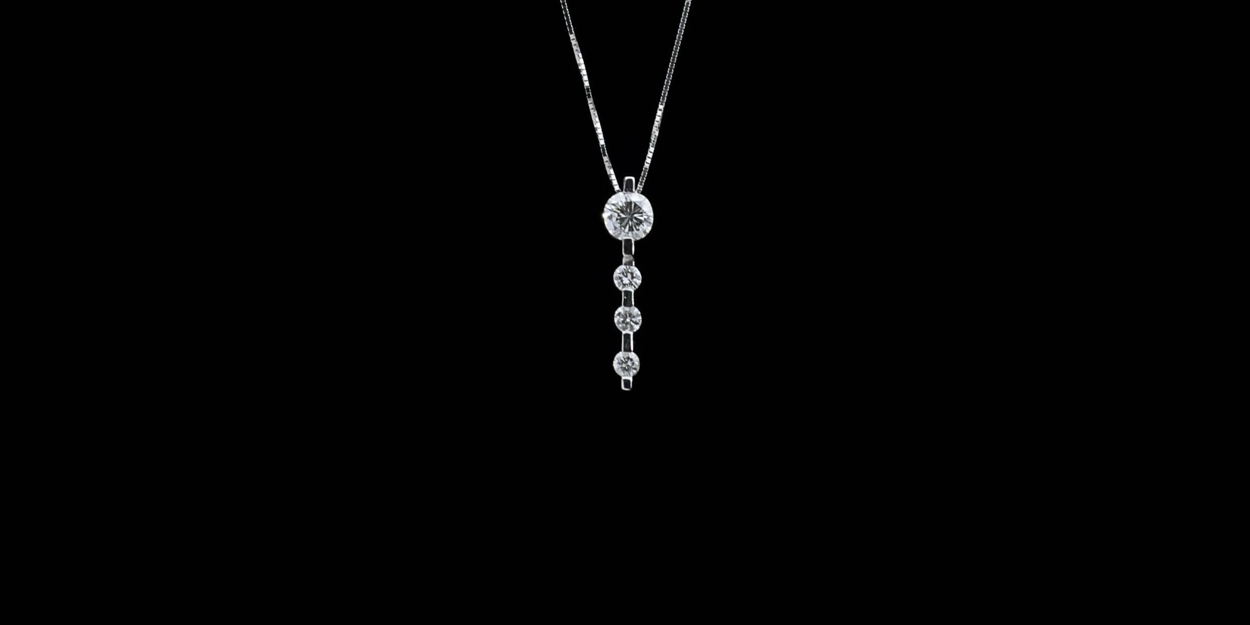 Simple yet elegant & beautiful would be the best way to describe this stunning pendant! It features 4 sparkly, round brilliant diamonds that have a combined total weight of .56 carats & grade as GH/SI in quality. The diamonds are channel set in a