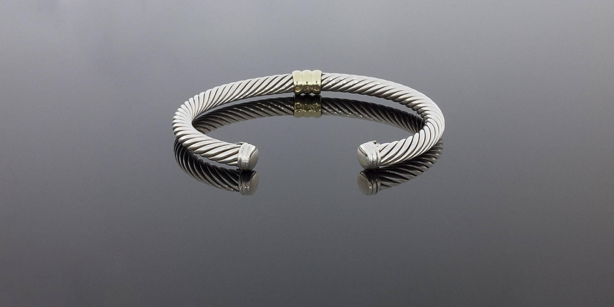 David Yurman's cable style jewelry has become his signature, the unifying element of every collection. This classic cuff bracelet features Yurman's iconic cable design in a 5mm width in sterling silver. The center is adorned with a ribbed station of