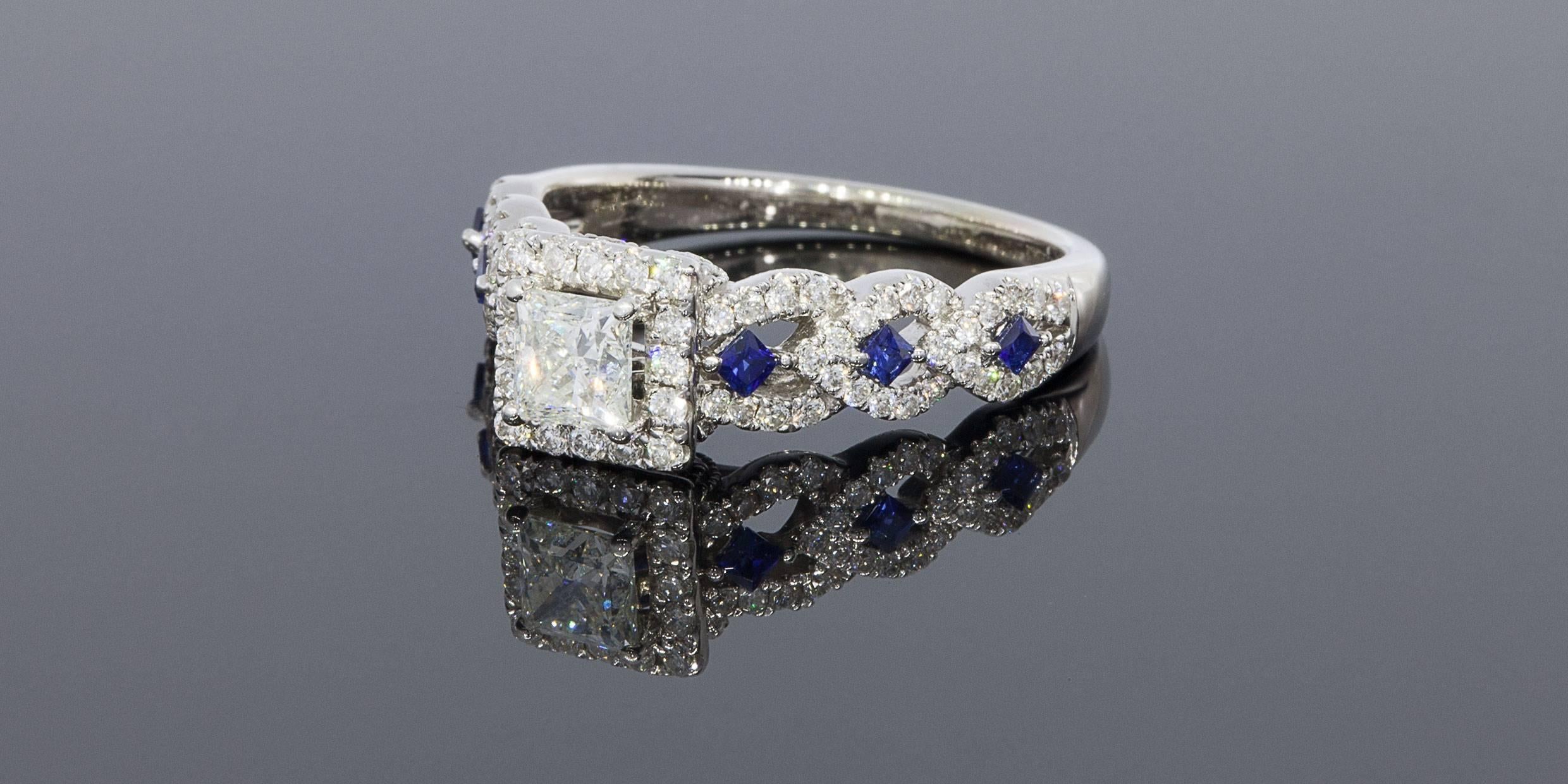 From the Vera Wang LOVE Collection, this captivating 14 karat white gold diamond and blue sapphire engagement ring offers incomparable beauty and unmatched quality. Take her breath away with this remarkable design, which features a 1/2 carat