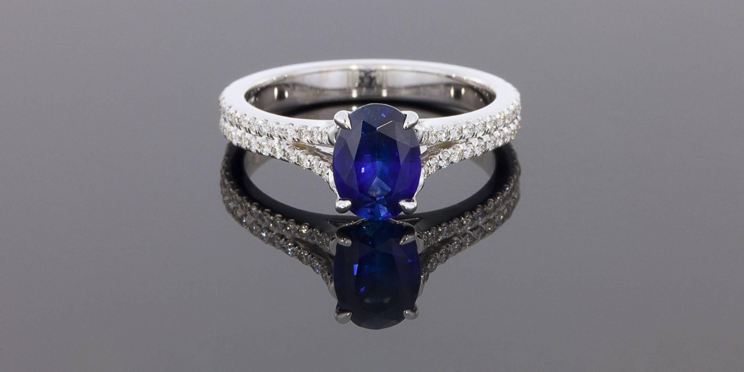 This breathtaking ring features a 1.36 carat, natural, AAA quality, oval, blue sapphire. This gorgeous sapphire has exceptionally beautiful blue color that can hardly be captured by pictures. It is prong set in a custom made, 14 karat white gold