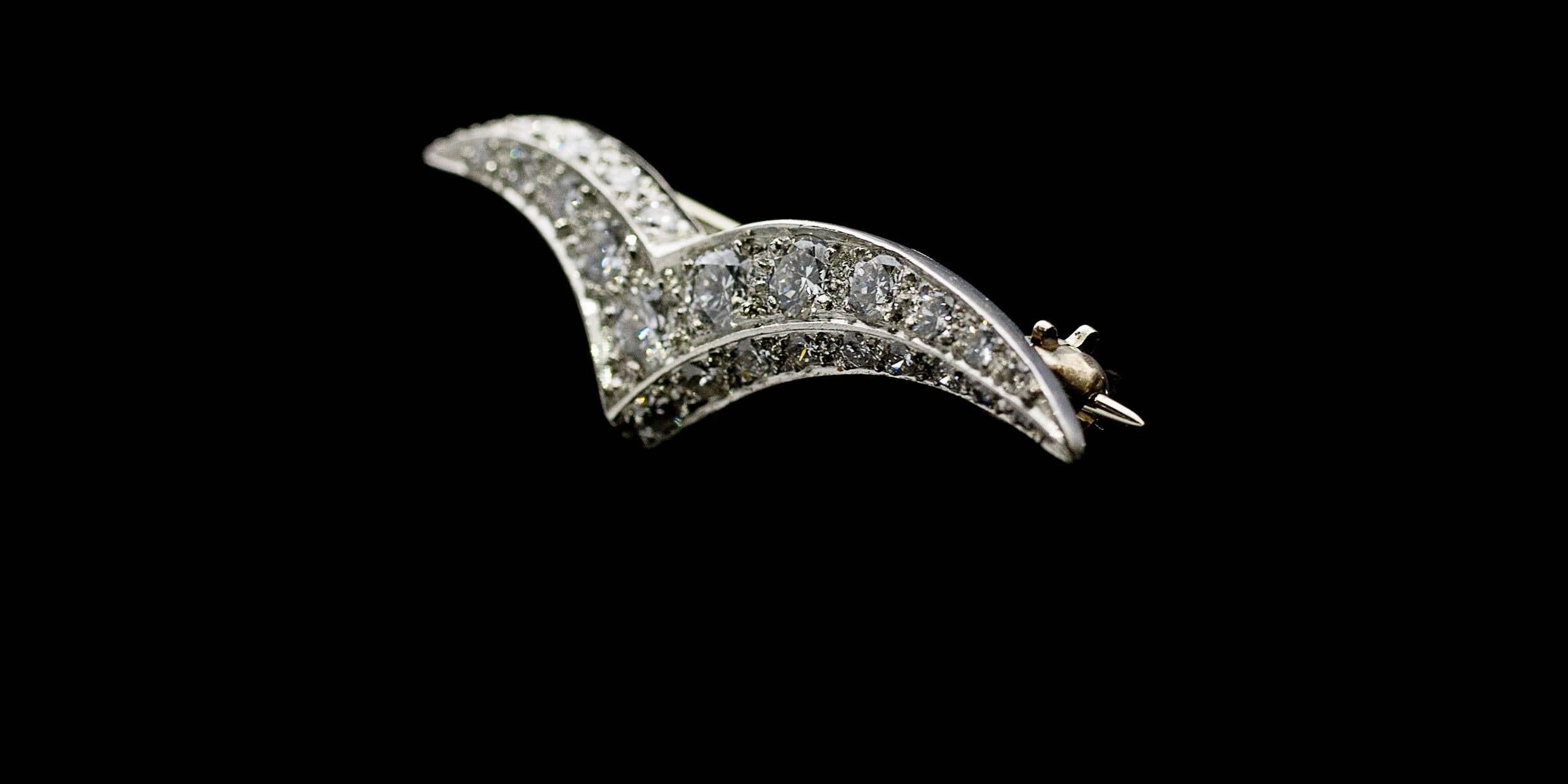 Tiffany & Co jewelry has long been admired for its quality and beauty, and this lovely vintage brooch is no exception. This brooch features .75 carats total diamond weight. The diamonds grade as EF/VVS in quality. The diamonds are set in a