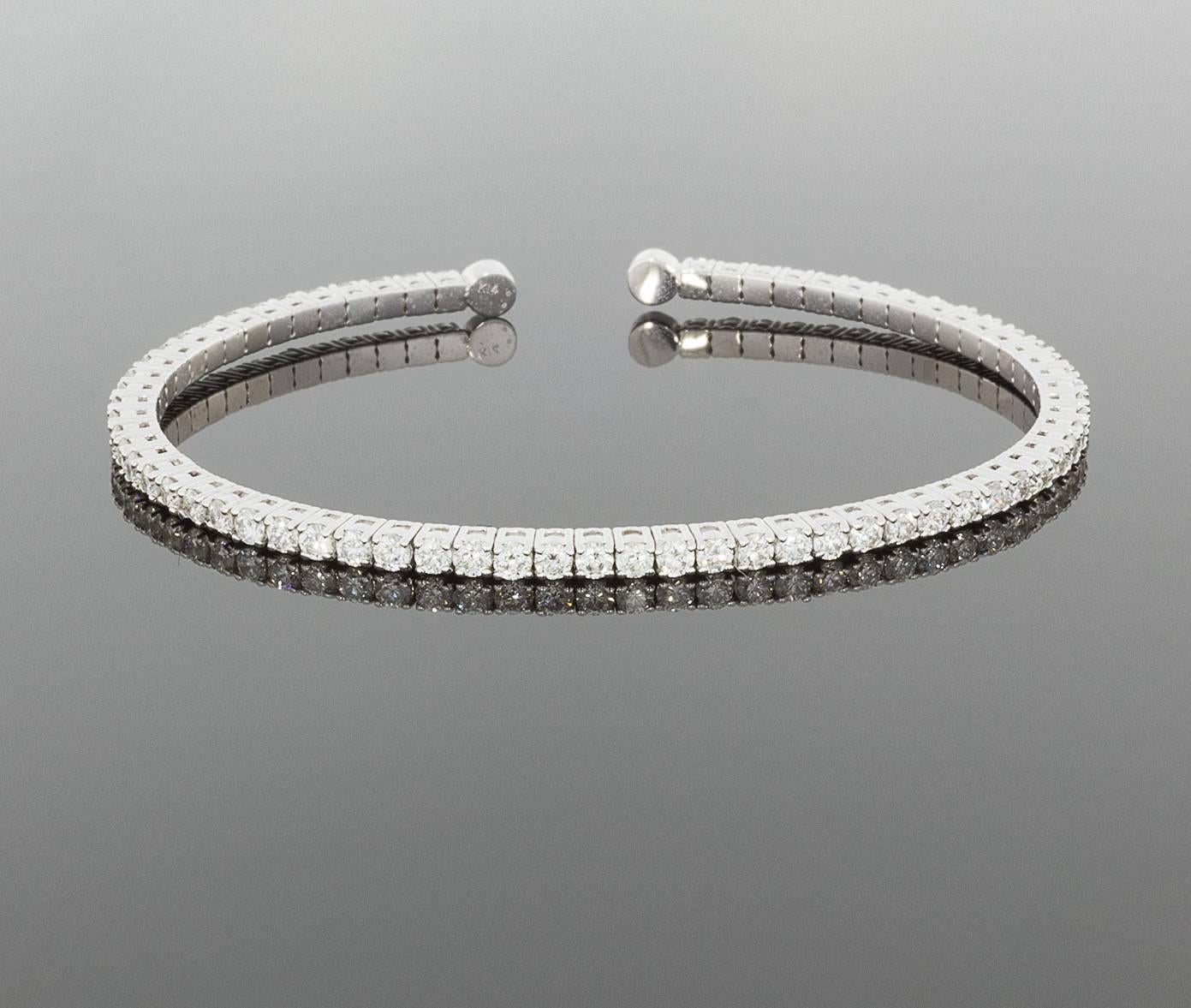 This beautiful diamond bracelet is a wonderfully updated version of the classic tennis bracelet. It is a prong set, flexible bangle bracelet, featuring 2.99 carats total weight in sparkly round diamonds. The bracelet is comprised of 14 karat white