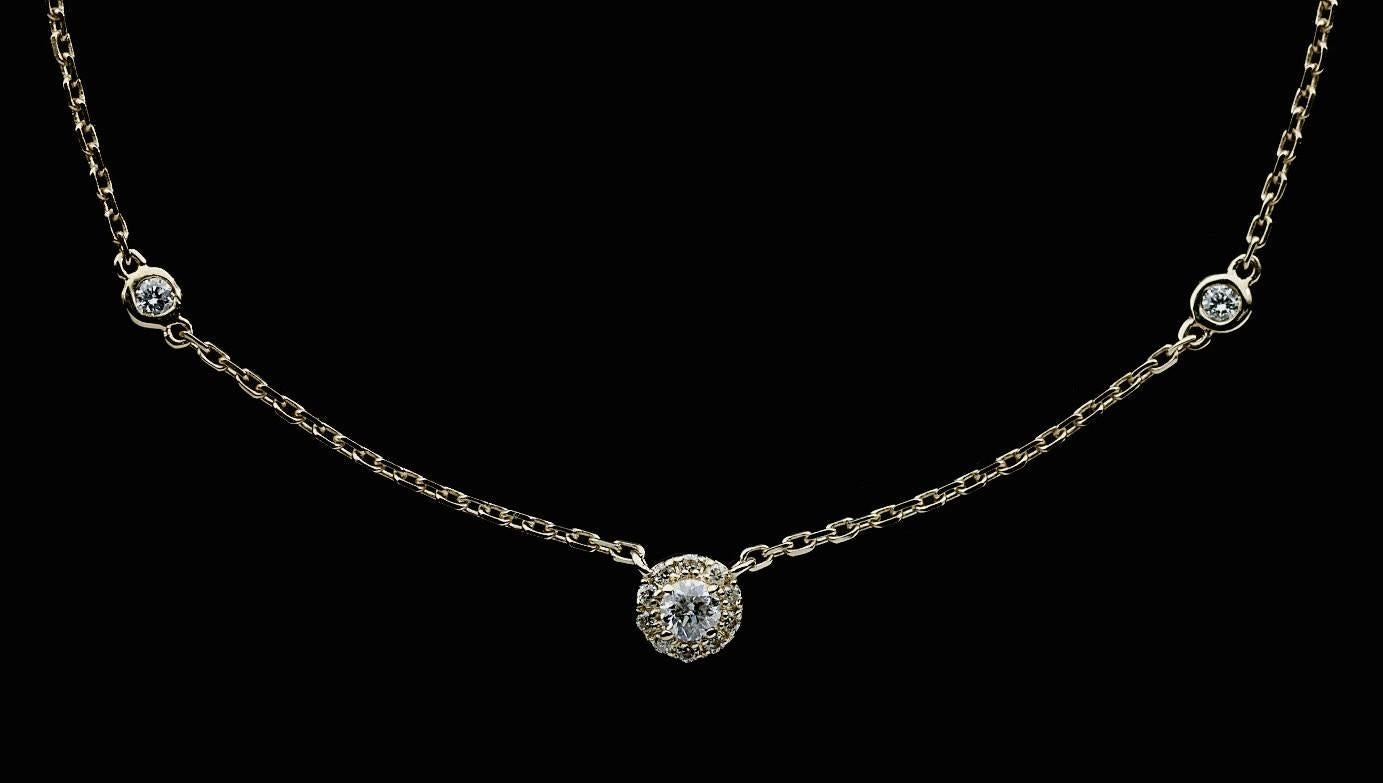 Simple yet elegant & beautiful would be the best way to describe this stunning necklace! It features a sparkly round diamond halo center that is attached to a yellow gold cable chain. The chain is a 