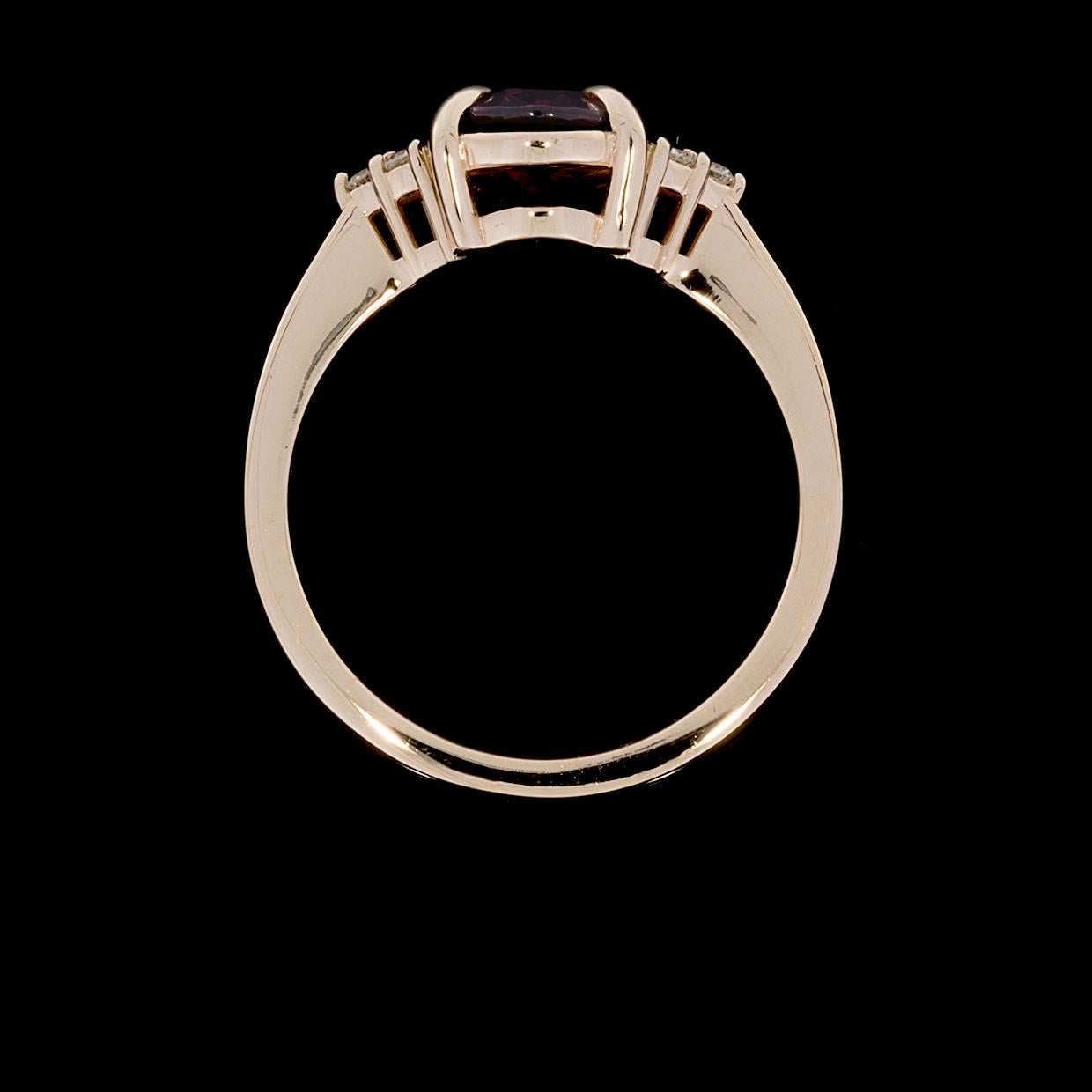 This lovely, fashion forward ring has a beautiful, timeless design that you'll love! The ring features an oval brilliant cut, natural, raspberry rhodolite garnet center that measures 9x7 millimeters in size & weighs approximately 2.25 carats. This