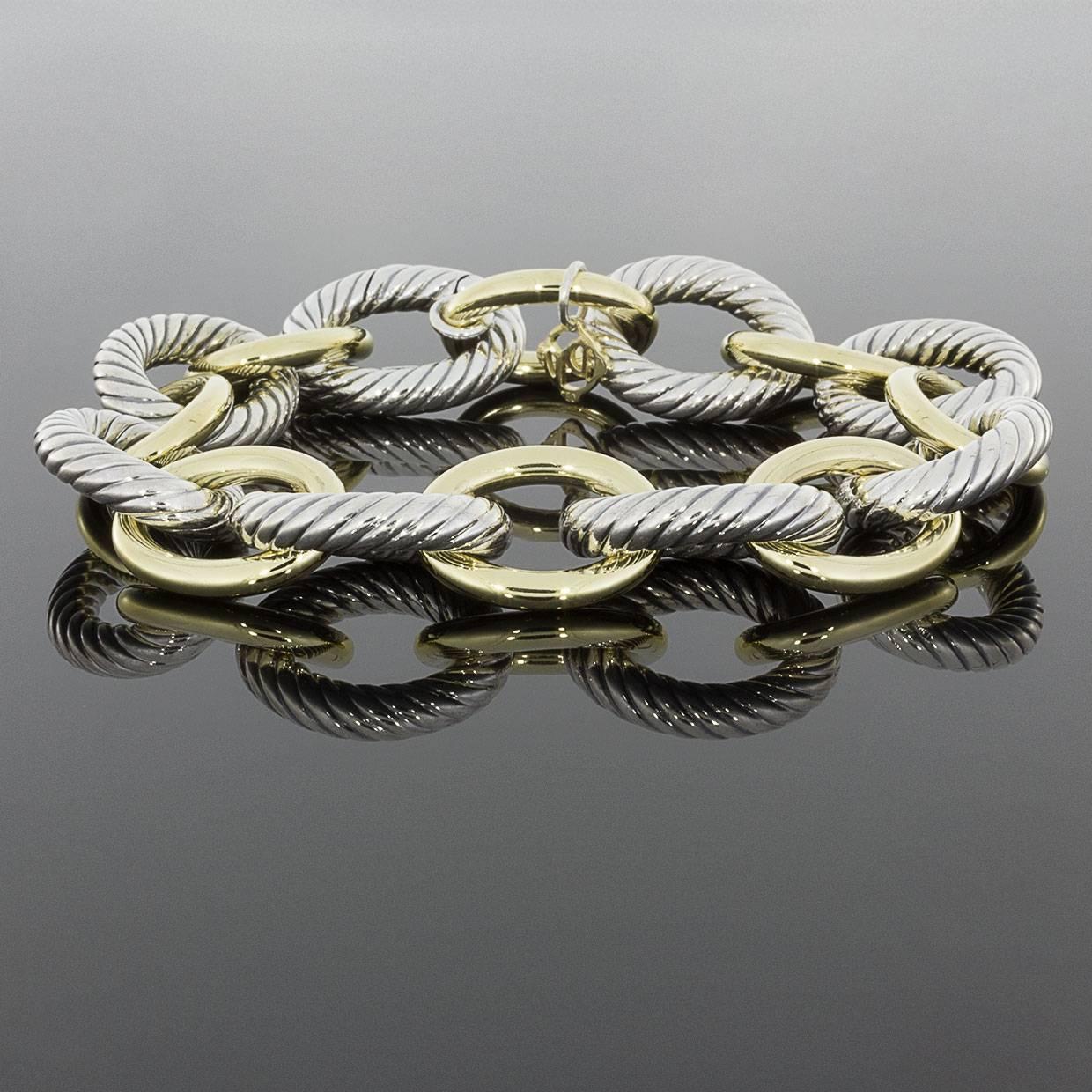 David Yurman's cable style jewelry has become his signature, the unifying element of every collection. This beautiful David Yurman bracelet is made of solid sterling silver & 18 karat yellow gold. The bracelet has a hidden hinge clasp. This classic