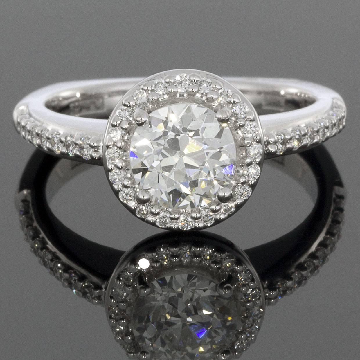 This beautiful wedding set is absolutely radiant in the shine of white gold! Sure to render her speechless, the engagement ring features a 1.0 carat round brilliant cut center diamond that is GIA certified and H/VS1 in quality. This lovely center