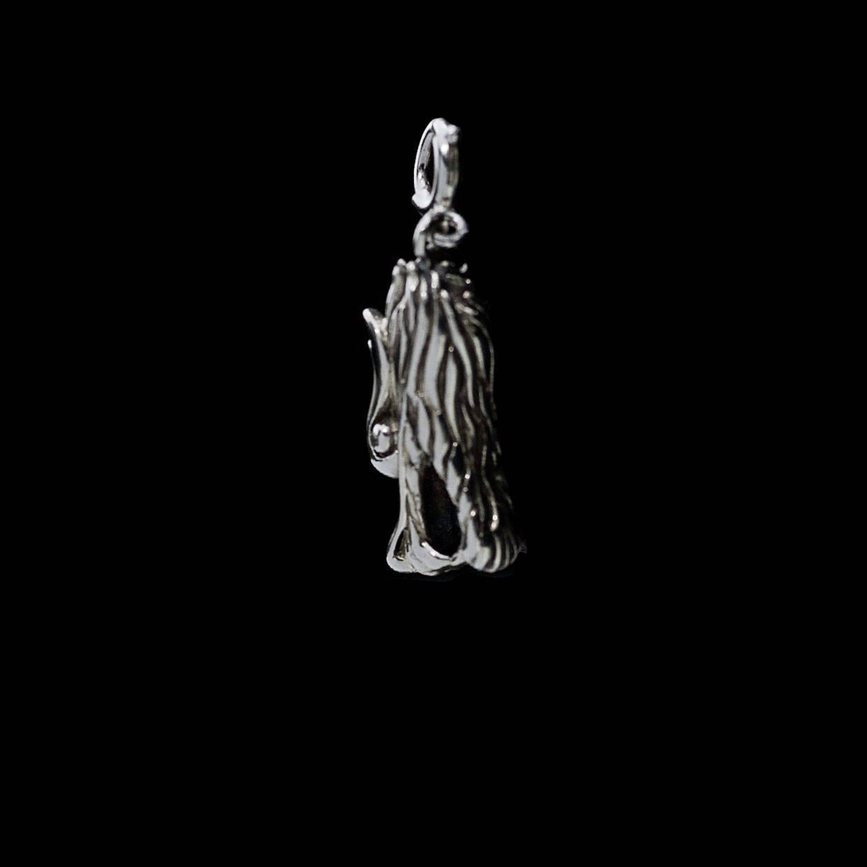 Each piece of John Hardy jewelry has been crafted in Bali since 1975. John Hardy is dedicated to creating timeless one-of-a-kind pieces that are brilliantly alive.

This sterling silver charm/pendant is from John Hardy's signature Naga collection.