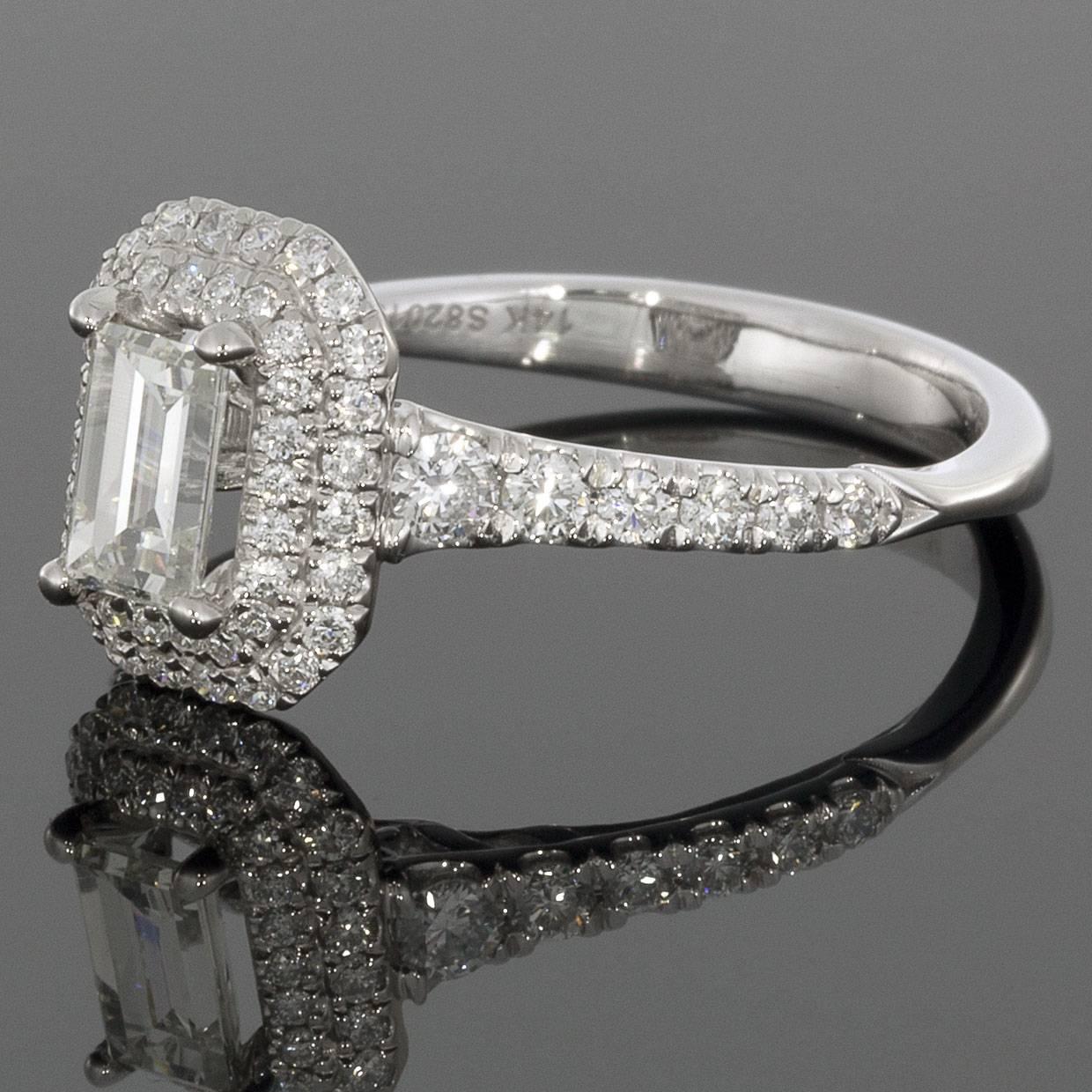 This classic diamond band would make a wonderful wedding band or anniversary ring. The ring is comprised of 14 karat white gold & features a double halo diamond design around a 0.50ct J/SI1. The ring is a finger size 6.5 & is sizable upon request.