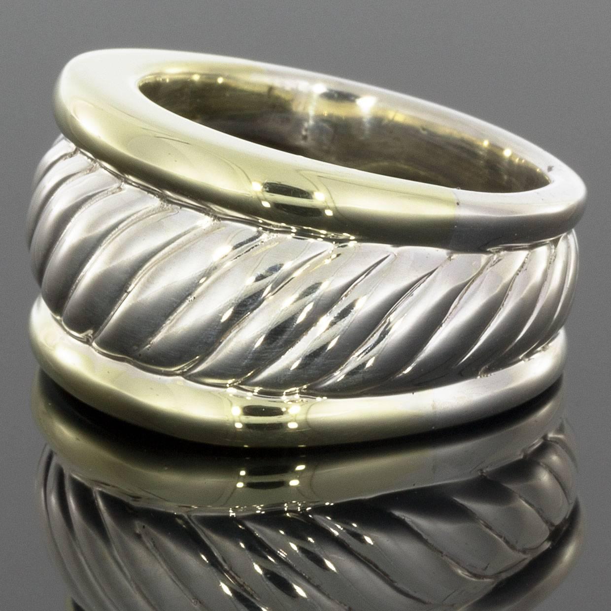 This beautiful David Yurman ring is from the Cable Classics Collection and features David Yurman's iconic cable design. The ring is made of sterling silver and 14 karat yellow gold with a high polished finish. This ring is a 6.5 and and 12 mm wide.
