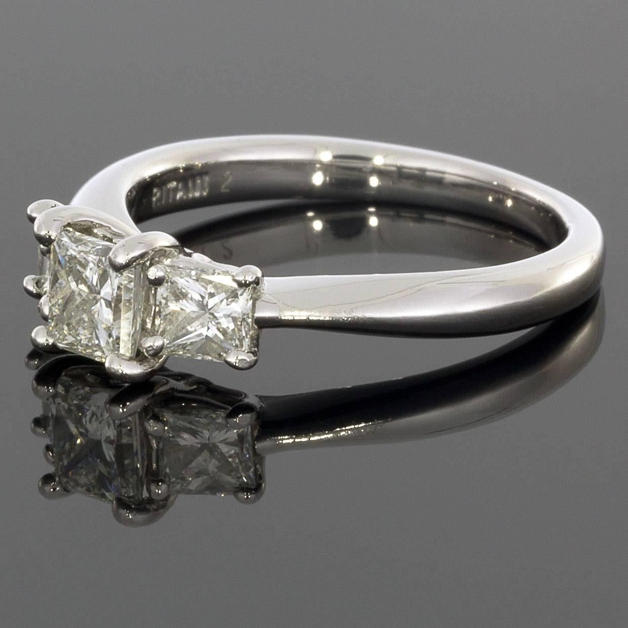 This lovely engagement ring features a beautiful three stone design. The three diamonds are princess cut gemstones that grade as I/SI1 in quality. The engagement ring has a combined total weight of .75 carat. The ring is comprised of platinum & is a
