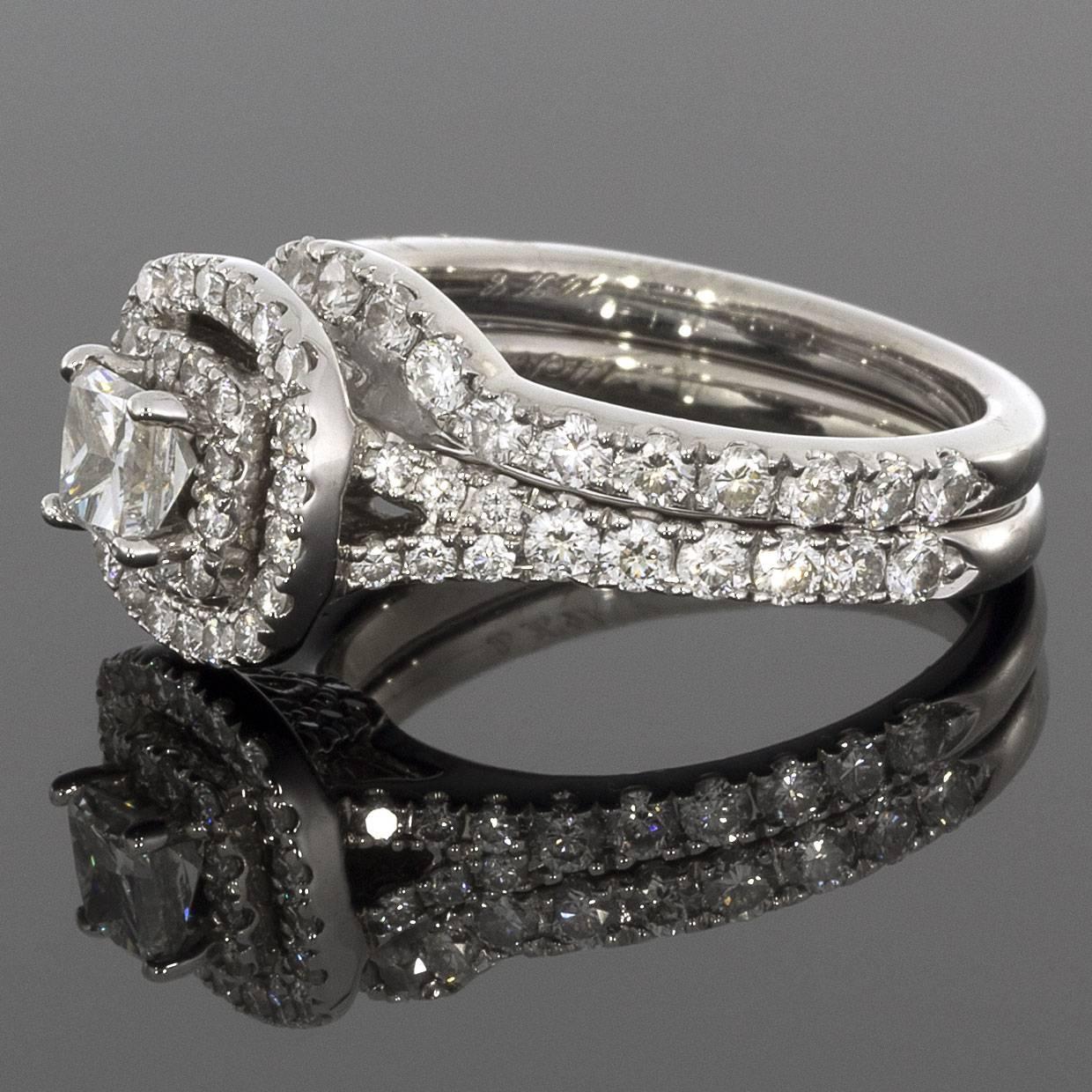 This lovely wedding set from the Neil Lane Bridal® collection features a beautiful double halo design. The center diamond is a princess cut diamond that is prong set and weighs .33 carat. The center stone has a clarity grade of I1. A double halo