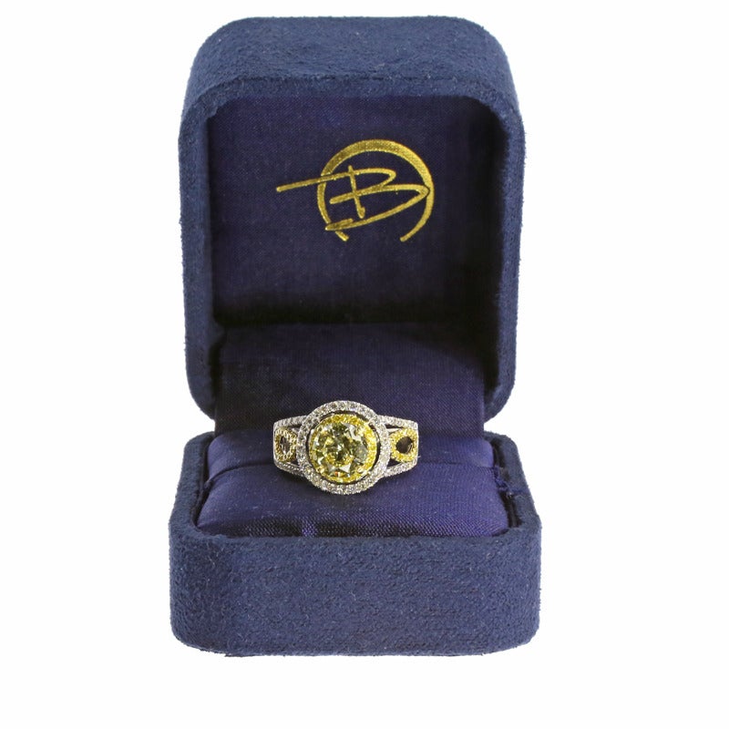 The ring features one round brilliant cut fancy yellow diamond weighing 1.44CT. The diamond is VS2 in clarity and is certified through the EGL. The ring also features 0.31CTW of canary round brilliant cut diamonds and 0.45CTW of round brilliant cut