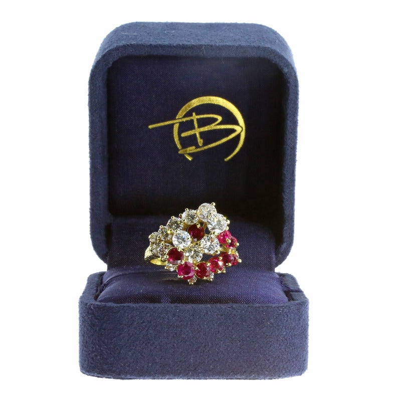 This exquisite ring features 15 round brilliant cut diamonds that weigh 2.83ctw & grade as GH/VS2-SI1. The ring also features 13 natural, red, round brilliant cut rubies weighing 2.35ctw. The diamonds & rubies have a combined total weight of 5.18