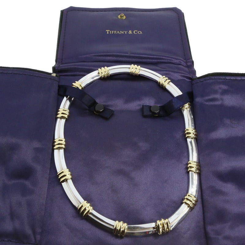 This gorgeous necklace is from the designer Tiffany & Co. & is part of the Bar Link Atlas line. Timeless & elegant, this necklace exudes class & style. Comprised of sterling silver and 18 karat yellow gold, the necklace comes with the original