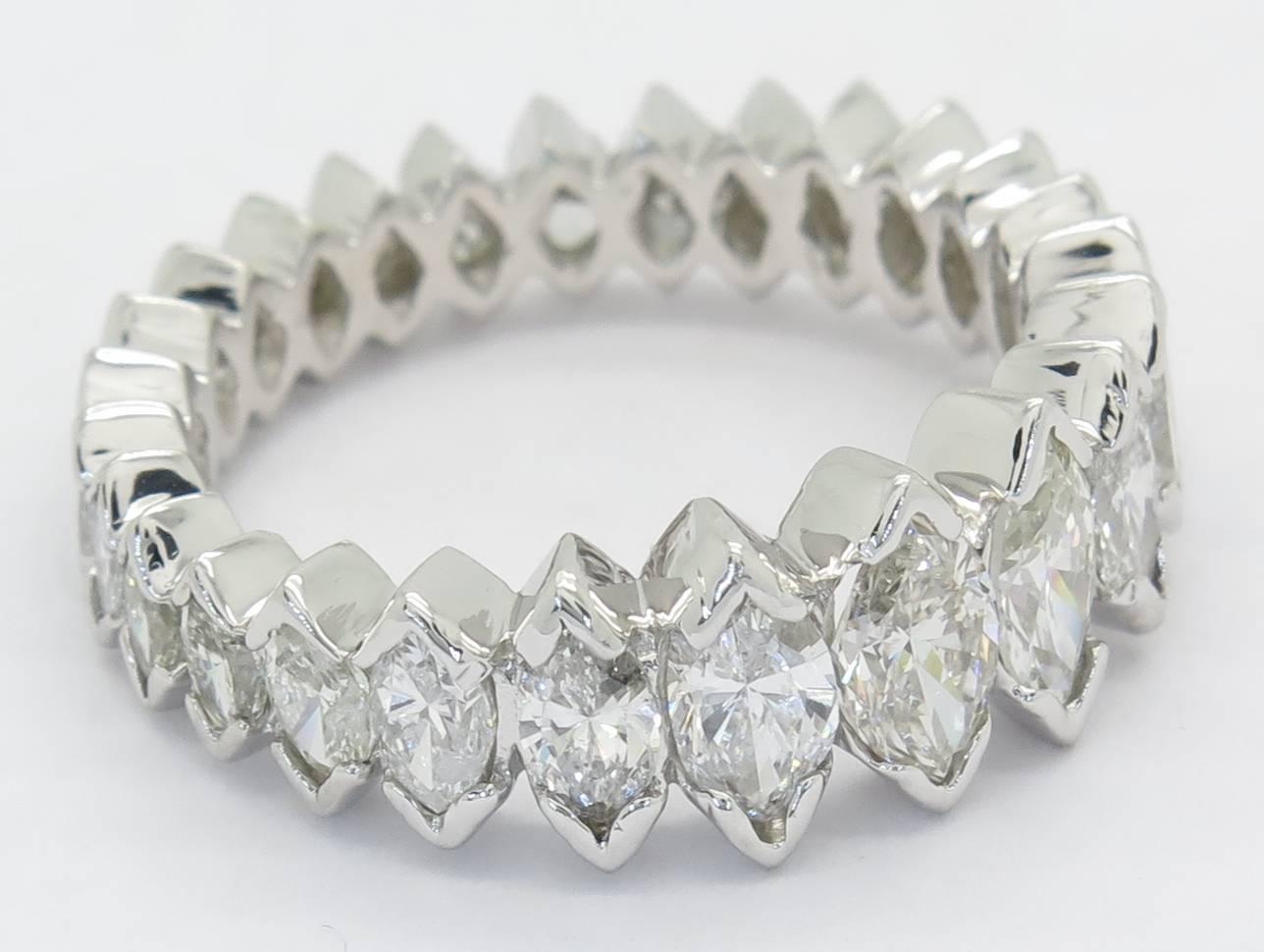 The band features 26 marquise cut diamonds weighing in total 3.00 carats. The diamodns are G-K in color range and SI1 in clarity. The diamonds are V-prong set in an eternity style. This stunning ring is a size 6 and cannot be sized. The band is
