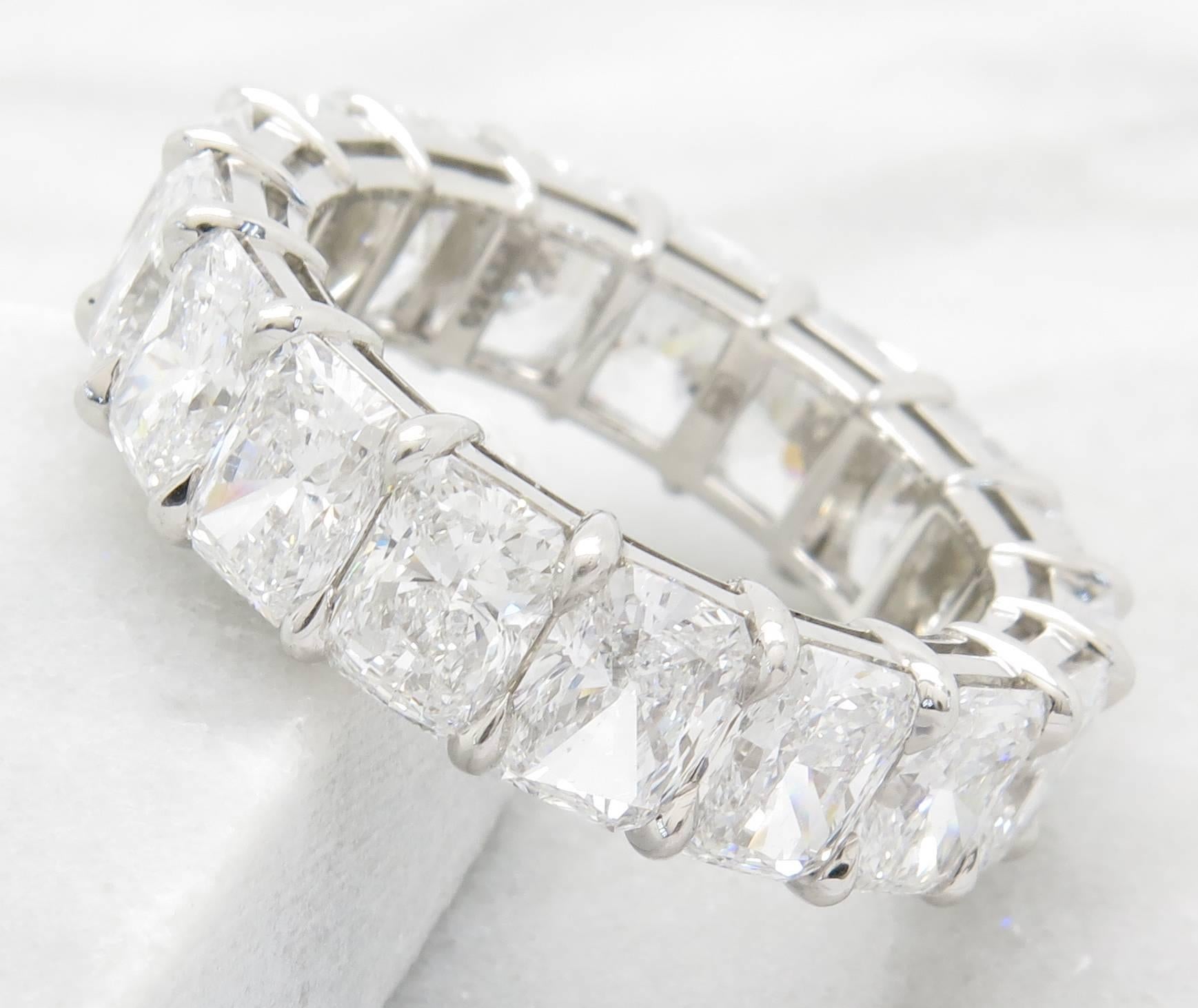 This breath-taking ring is from the world renowned designer Harry Winston. The band features 17 radiant brilliant cut diamonds weighing in total 9.35 carats. The diamonds are D-E in color (colorless) and VS1-VS2 in clarity. The diamonds are prong