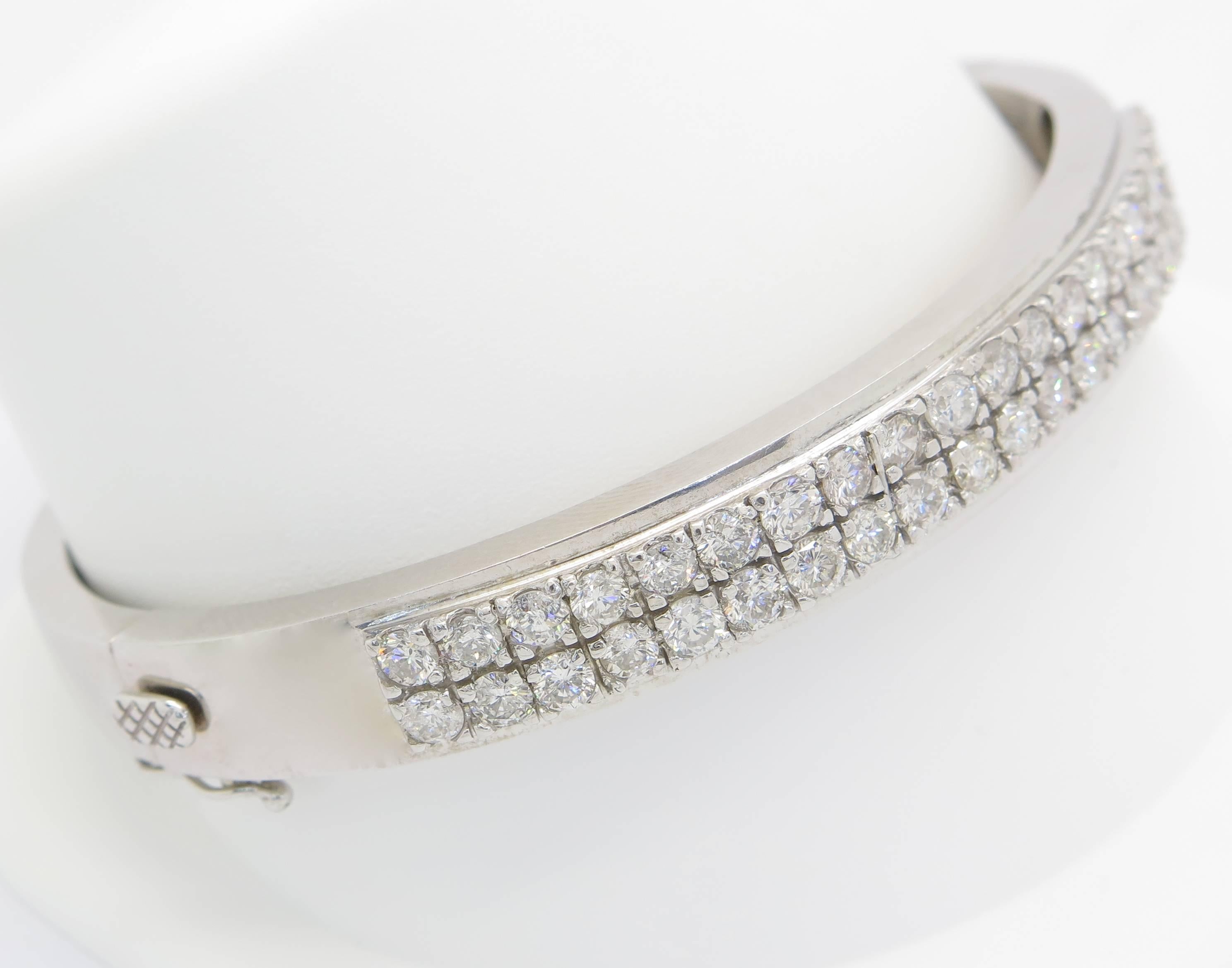 The bangle features 40 round brilliant cut diamonds weighing in total 4.00 carats. The diamonds are G-I in color and SI1 in clarity. The diamonds are prong set in a double row bangle style bracelet. This timeless piece would make a perfect addition