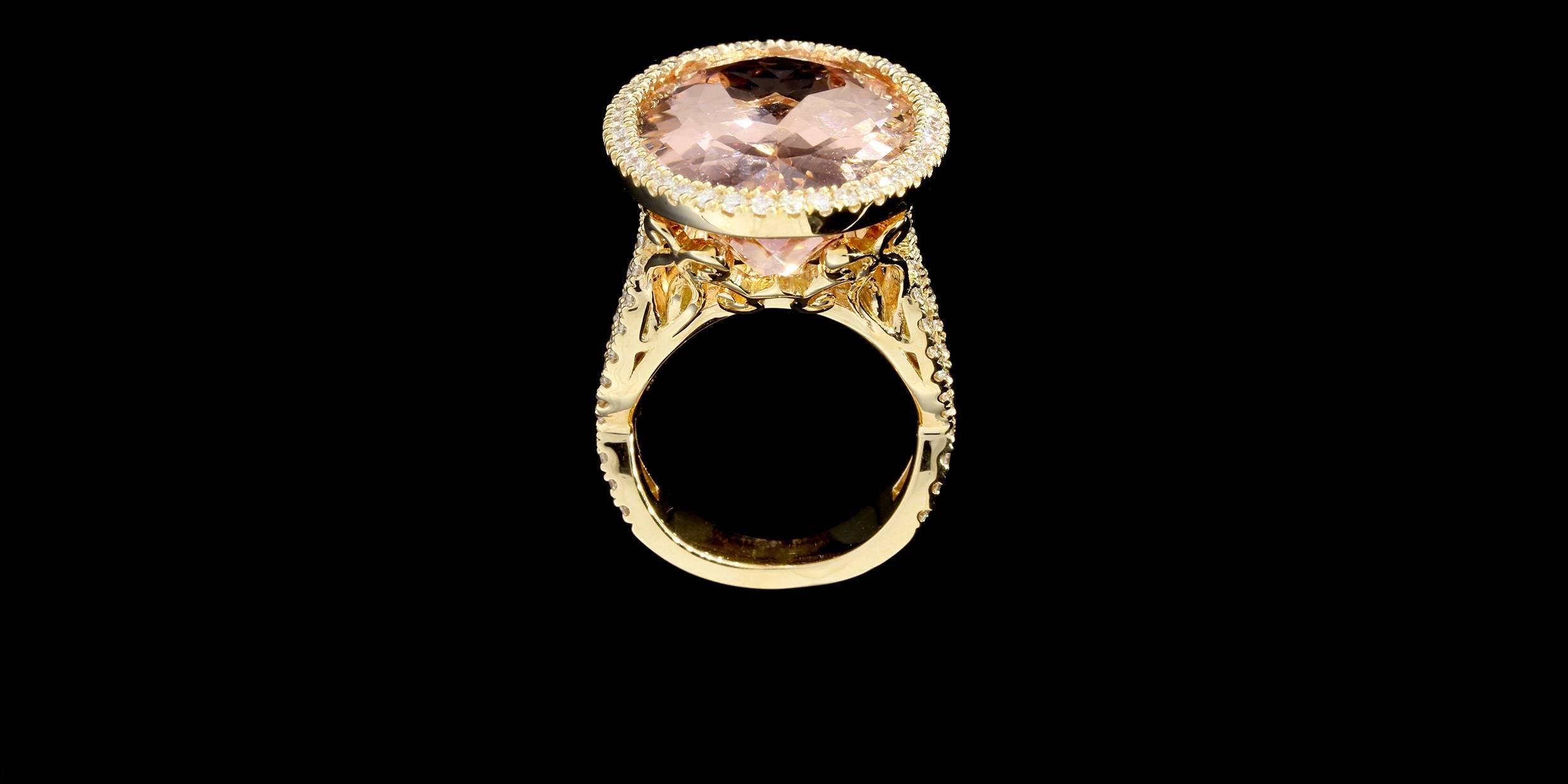 This ring features a 21.00 carat oval shaped Morganite burnish set in a diamond halo.  The ring features 1.39ctw of diamonds with the quality G/SI1 in the halo and shank.  The shank of the ring is a vintage inspired twist shank with an ornate under