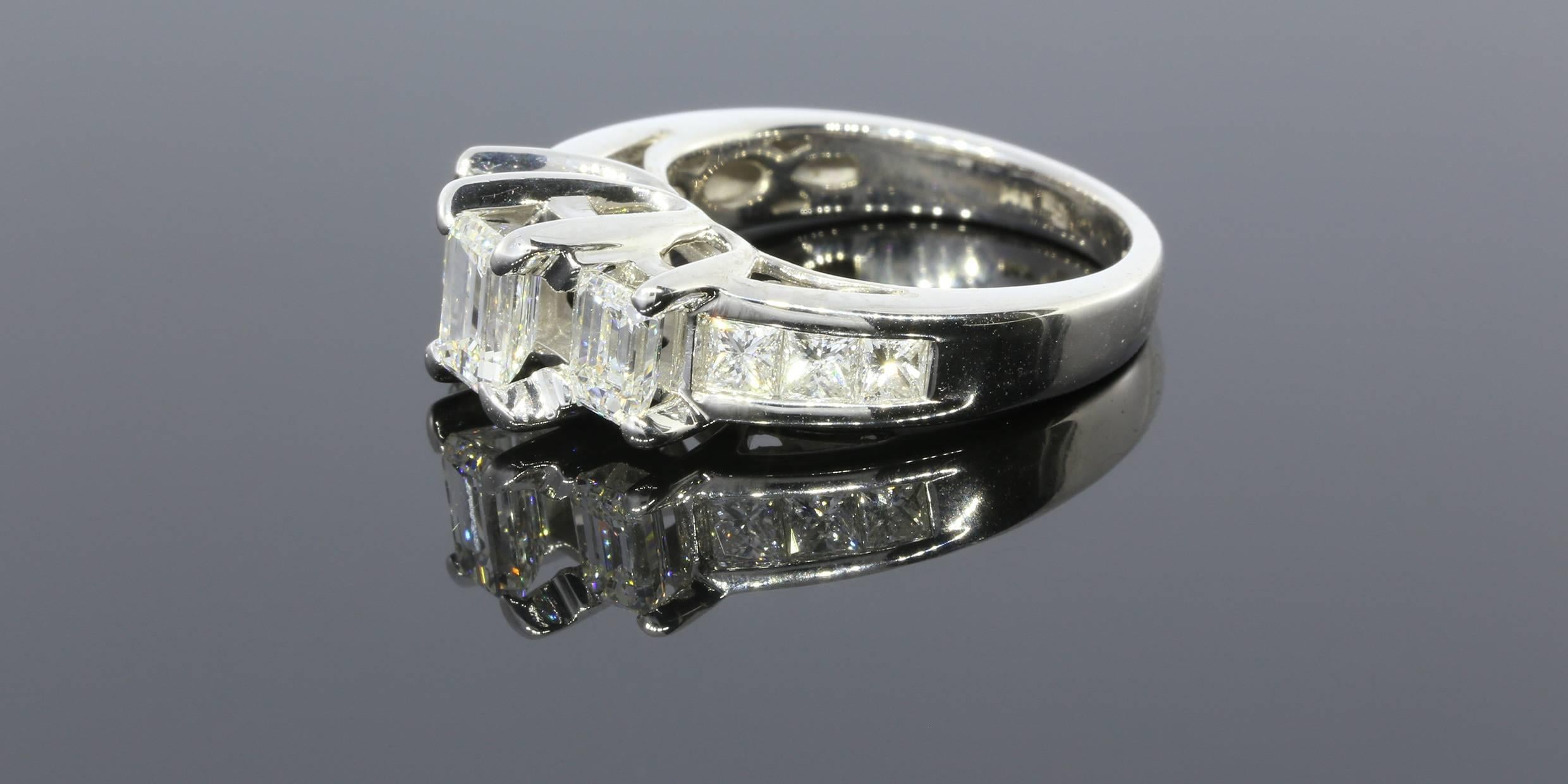 This ring features 3 emerald cut diamonds prong set in a 3-stone style mounting and three princess cut diamonds channel set on either side.  The center stone is a 0.60ct emerald cut diamond with 0.40ct emerald cut stones on either side. The channel