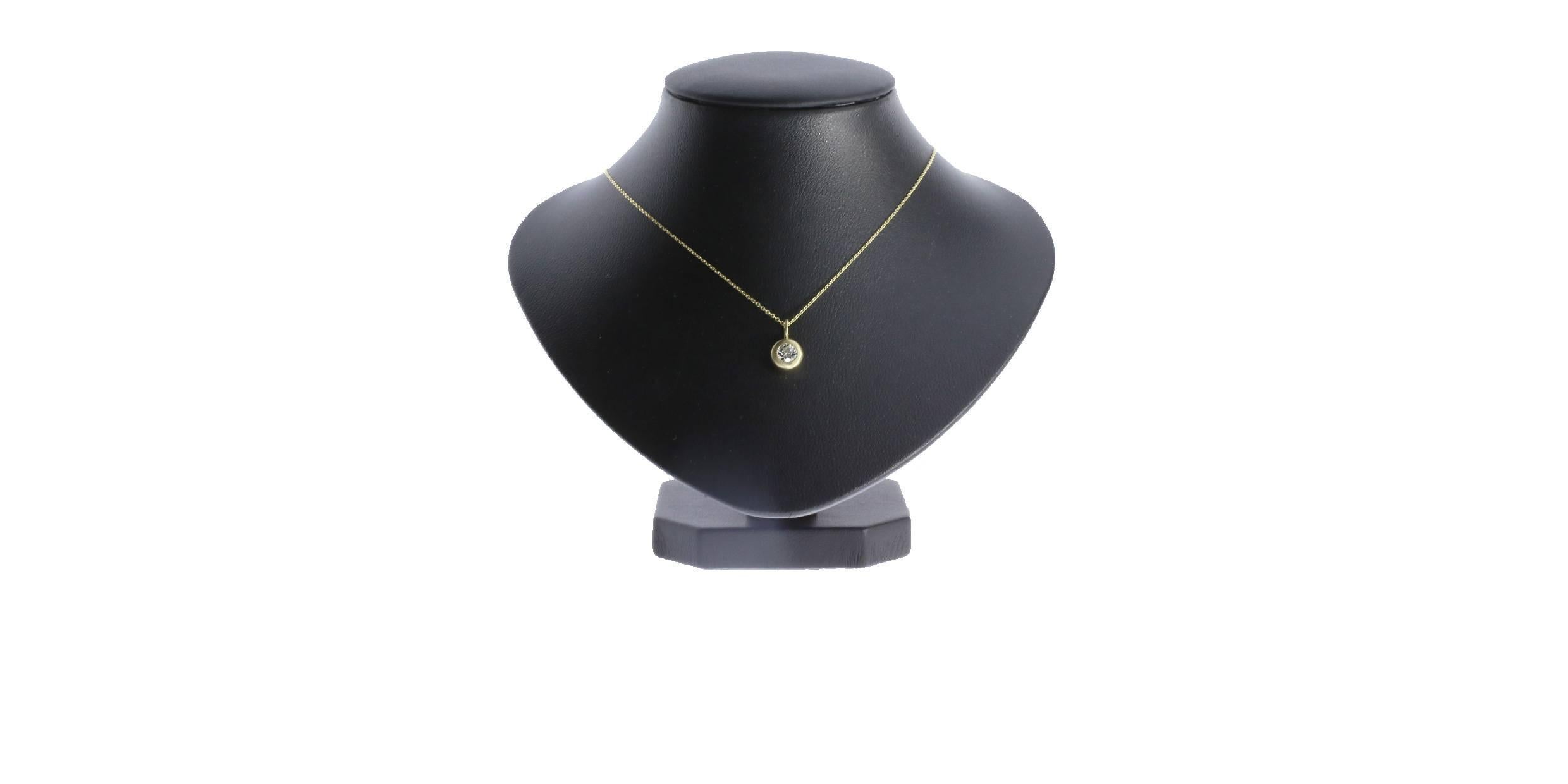 This pendant features a 0.30 carat I/SI1 round diamond bezel set in a 14k yellow gold pendant.  The pendant features a striking brush finish, creating a stunning contrast. The pendant measures 12mm in length including the bail.  It is suspended from