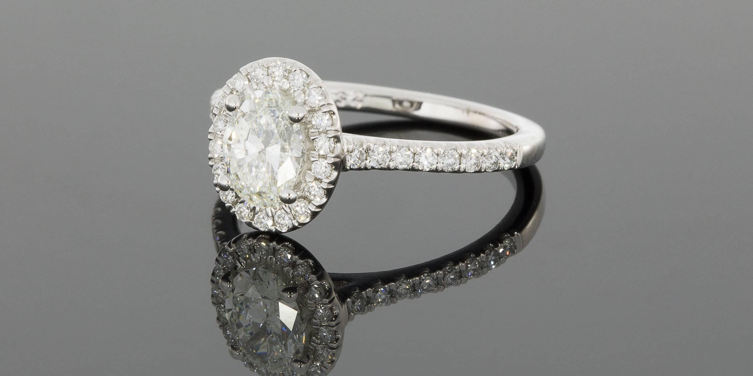 This gorgeous diamond halo engagement ring is from the designer Martin Flyer. This 65 year old, third generation family owned business handcrafts all their rings with extraordinary attention to detail, using only the highest quality, Hearts & Arrows