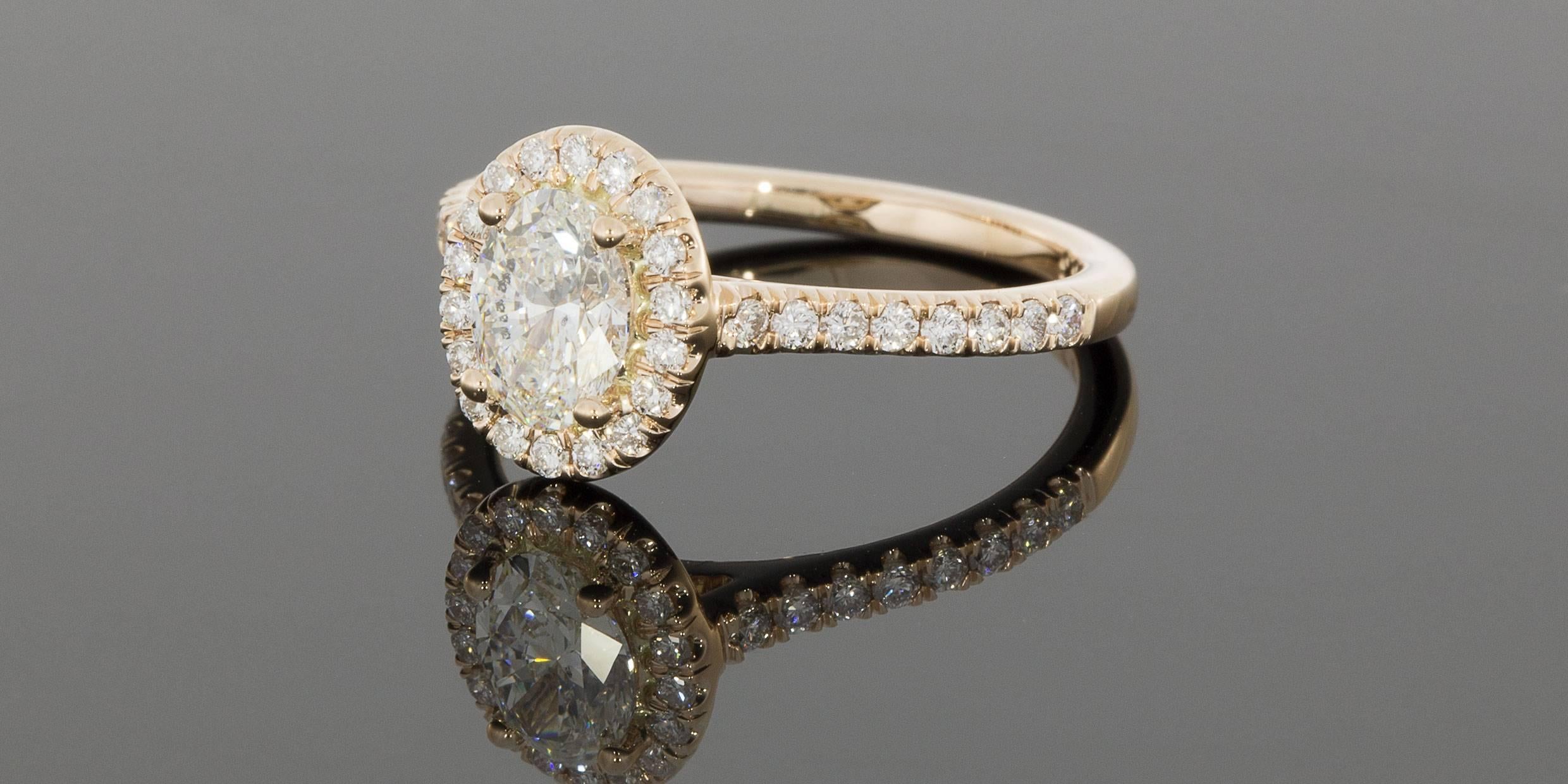 This gorgeous diamond halo engagement ring is from the designer Martin Flyer. This 65 year old, third generation family owned business handcrafts all their rings with extraordinary attention to detail, using only the highest quality, Hearts & Arrows