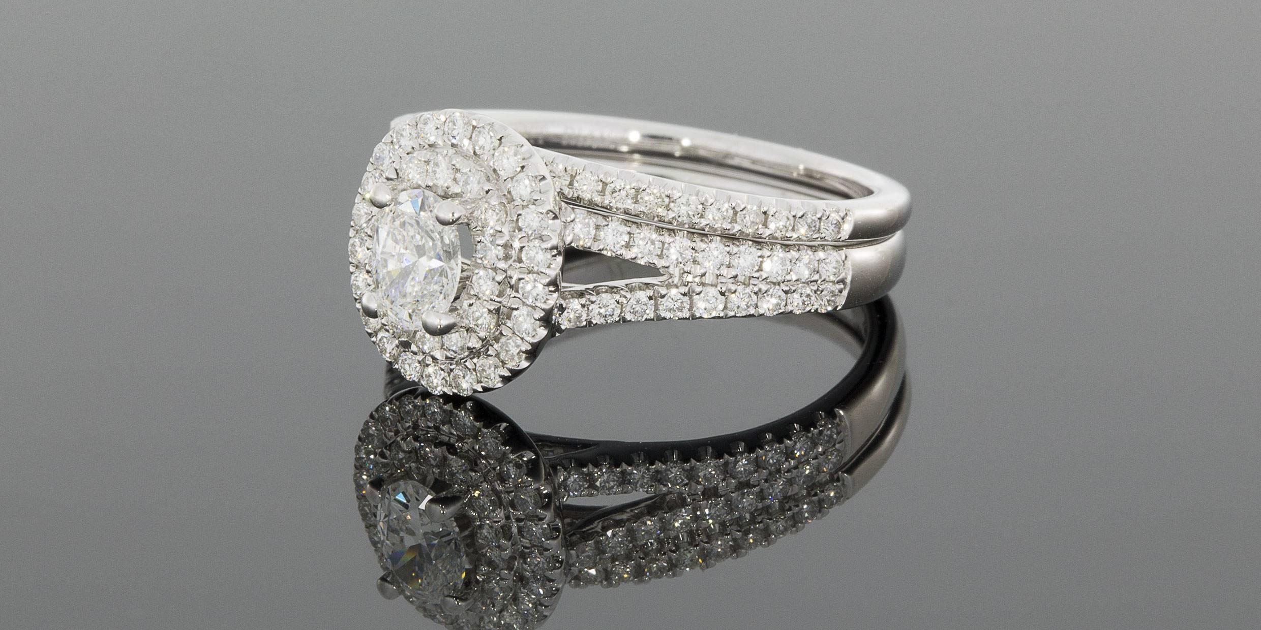 

Render her speechless with this gorgeous oval diamond wedding set! The engagement ring features a .36 carat oval diamond that grades as H/SI2 in quality. This sparkly diamond is prong set in a 14 karat white gold ring. The setting features a