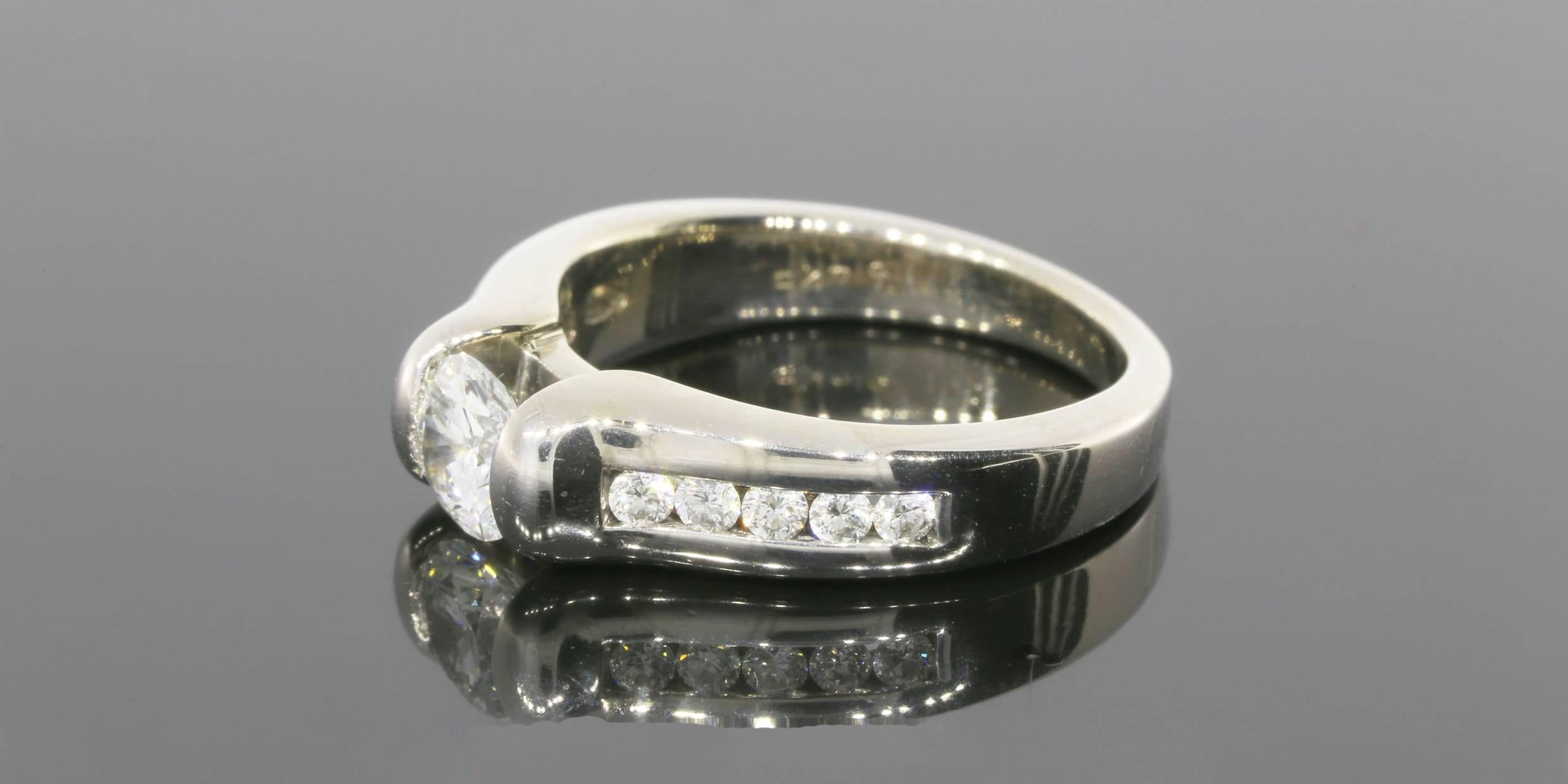 This beautiful diamond engagement ring features 1 carat total weight in sparkly round brilliant diamonds. The center diamond is a .60 carat round brilliant cut diamond that grades as H/SI1 in quality. It is tension set in a 14 karat white gold ring.