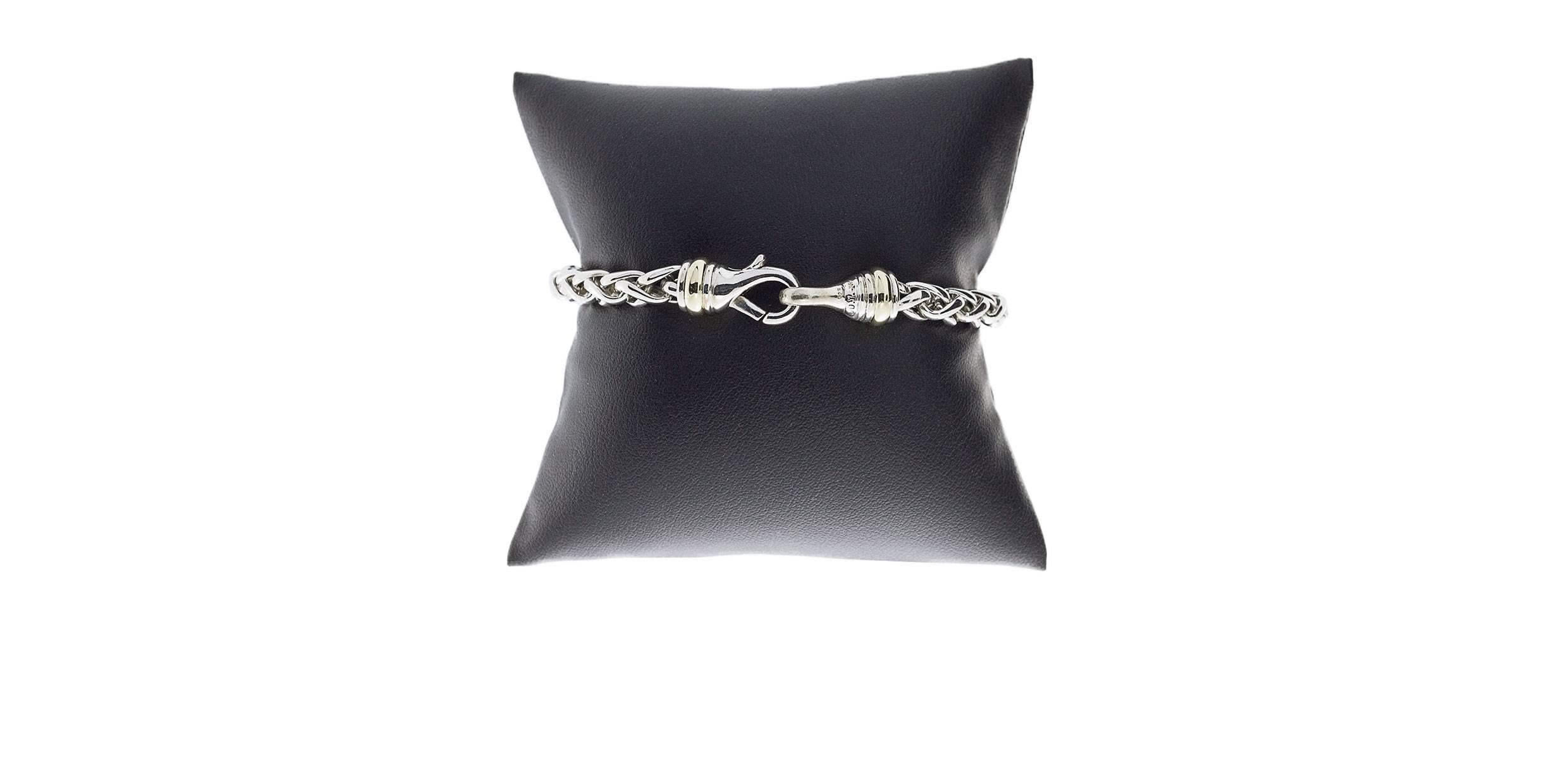 This beautiful bracelet is from David Yurman, a legend in the jewelry business. This versatile, wheat chain bracelet is comprised of sterling silver with 14 karat yellow gold accents. It is 7.75