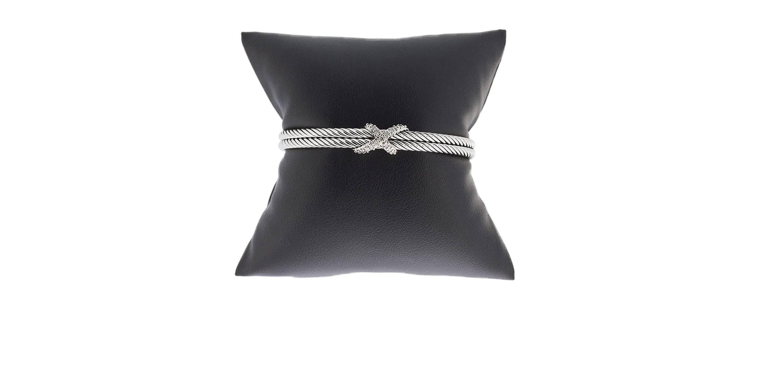 David Yurman's cable style jewelry has become his signature, the unifying element of every collection. This beautiful cuff bracelet from the X Collection features a double cable design in sterling silver. The center has a diamond set 