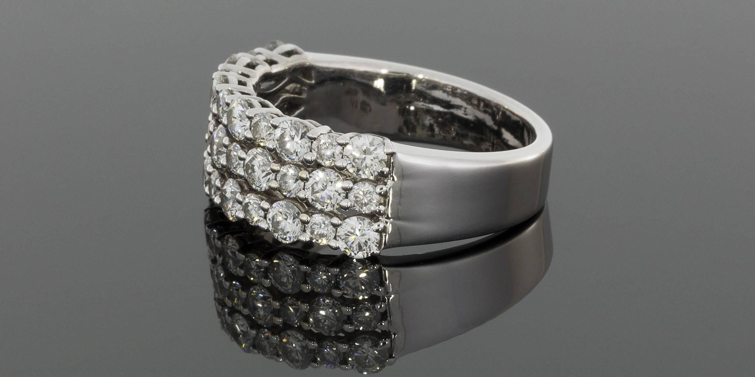 This beautiful & sparkly ring features 37 round brilliant diamonds that have a combined total weight of 1.73 carats. The diamonds are shared prong set, alternating between larger & smaller diamonds, in a three row style band. The ring is
