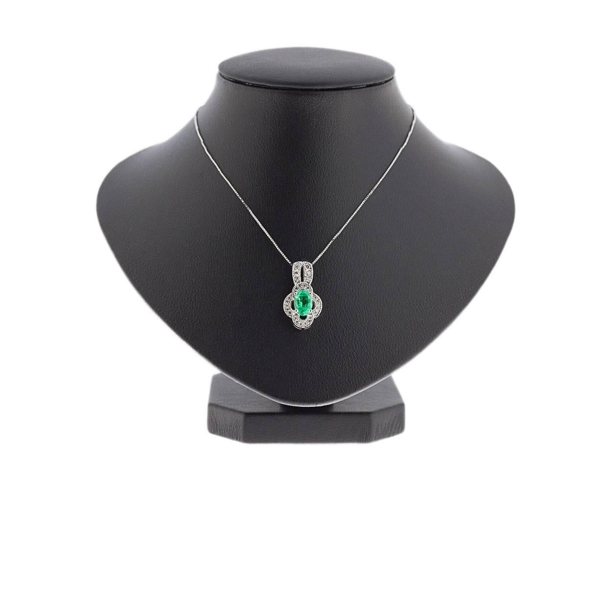 Simple yet elegant & beautiful would be the best way to describe this stunning necklace! It features a .85 carat, oval cut, natural, green emerald that is prong set in 14 karat white gold. The pendant also features a beautiful scalloped design halo