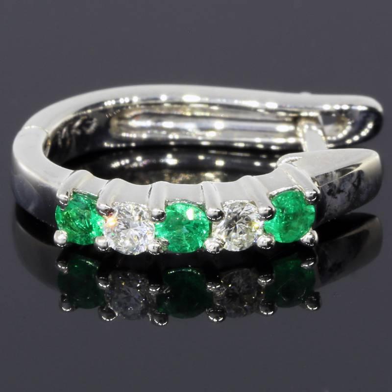 These lovely earrings feature 6 round emeralds & 4 round brilliant cut diamonds that have a combined total weight of 0.38 carat. The emeralds have a beautiful, vibrant green color. The diamonds are GH/SI in quality. The stones are shared prong