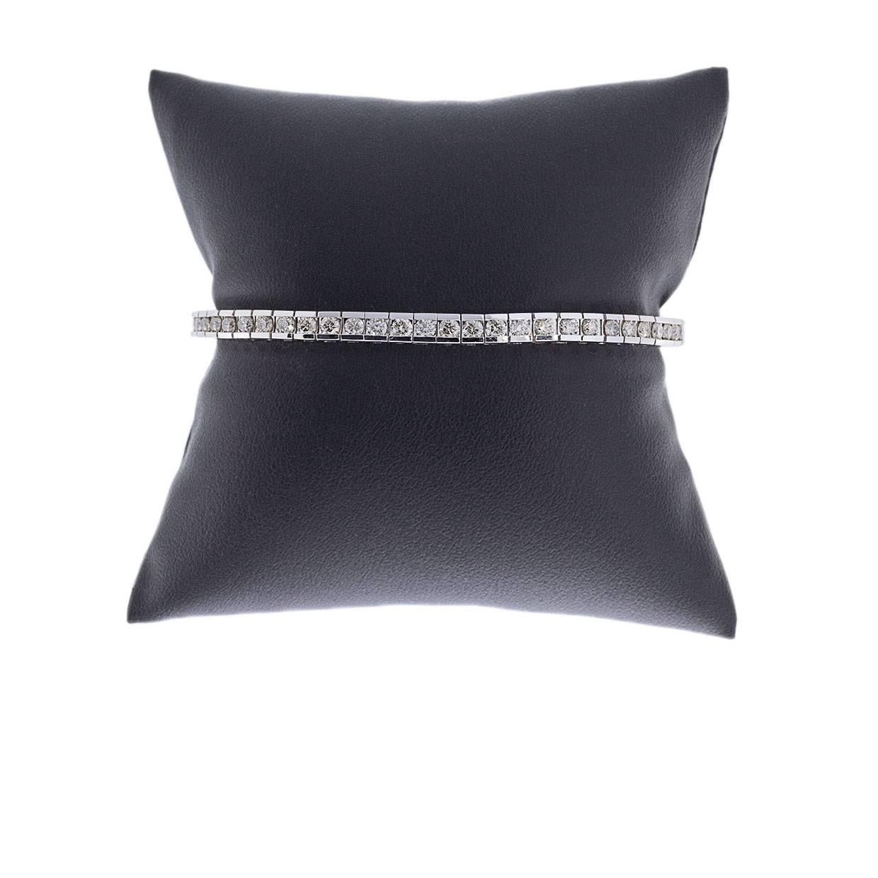 This beautiful diamond bracelet is perfect for the classy, woman-on-the-go! It features 56 round brilliant cut diamonds that have a combined total weight of 5.01 carats. These scintillating diamonds are securely channel set in a 14 karat white gold