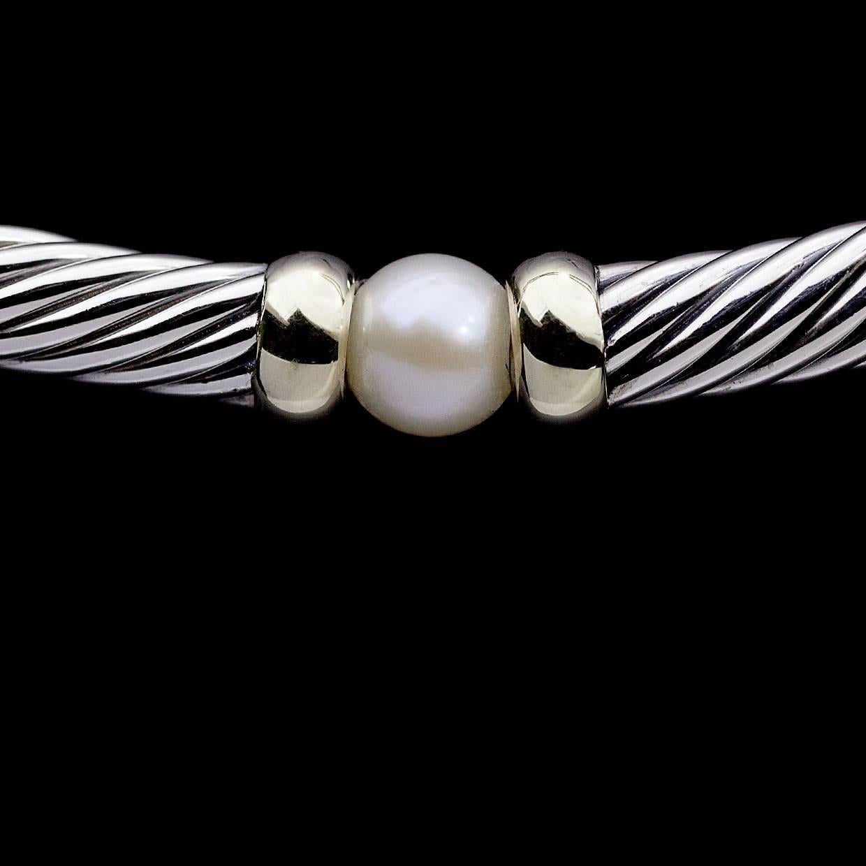 David Yurman's cable style jewelry has become his signature, the unifying element of every collection. This classic necklace is from Yurman's Hampton Collectin. It features 6 beautiful cultured pearls in between 14 karat yellow gold accents &