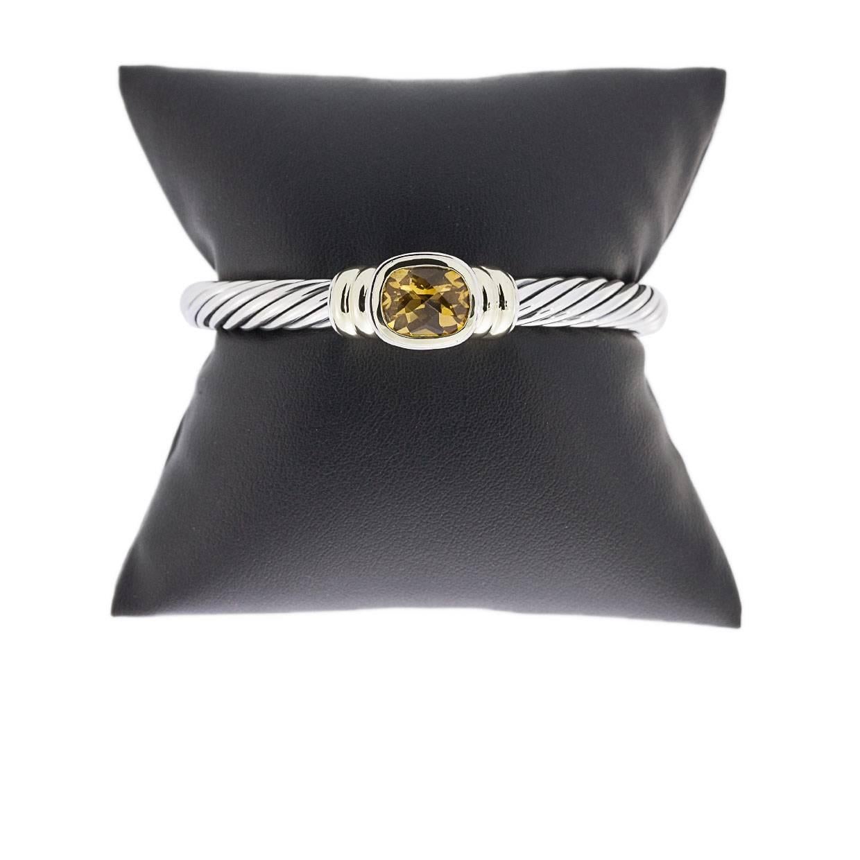 David Yurman's cable style jewelry has become his signature, the unifying element of every collection. This classic cuff bracelet from Yurman's Noblesse Collection showcases that iconic cable design in sterling silver & 14 karat yellow gold. The