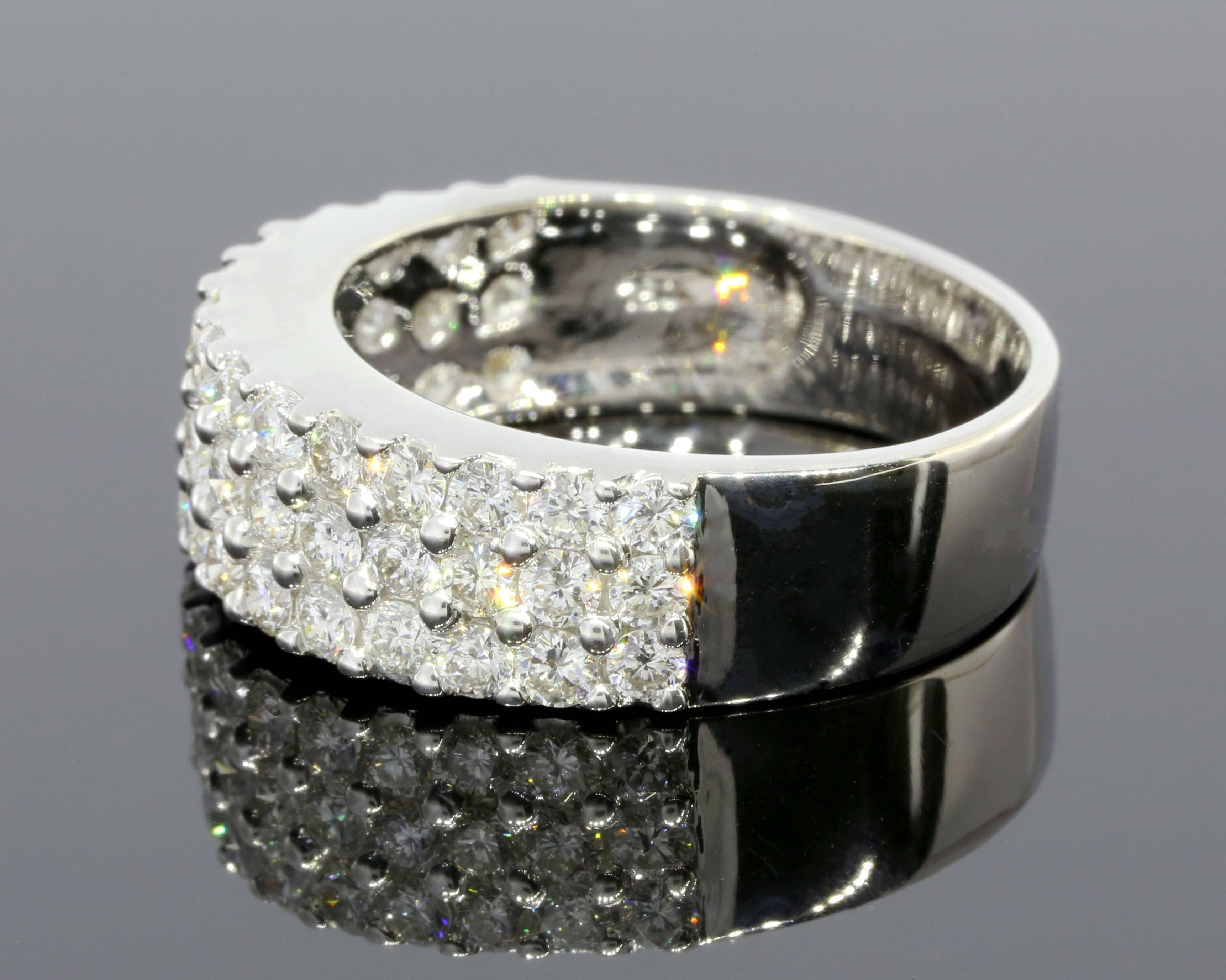 This gorgeous ring has tons of sparkle & is just breathtaking! The ring features 3 rows of shared prong set, round brilliant cut diamonds that have a combined total weight of 2.25 carats. These beautiful diamonds grade as GH/VS2-SI2 in quality. The