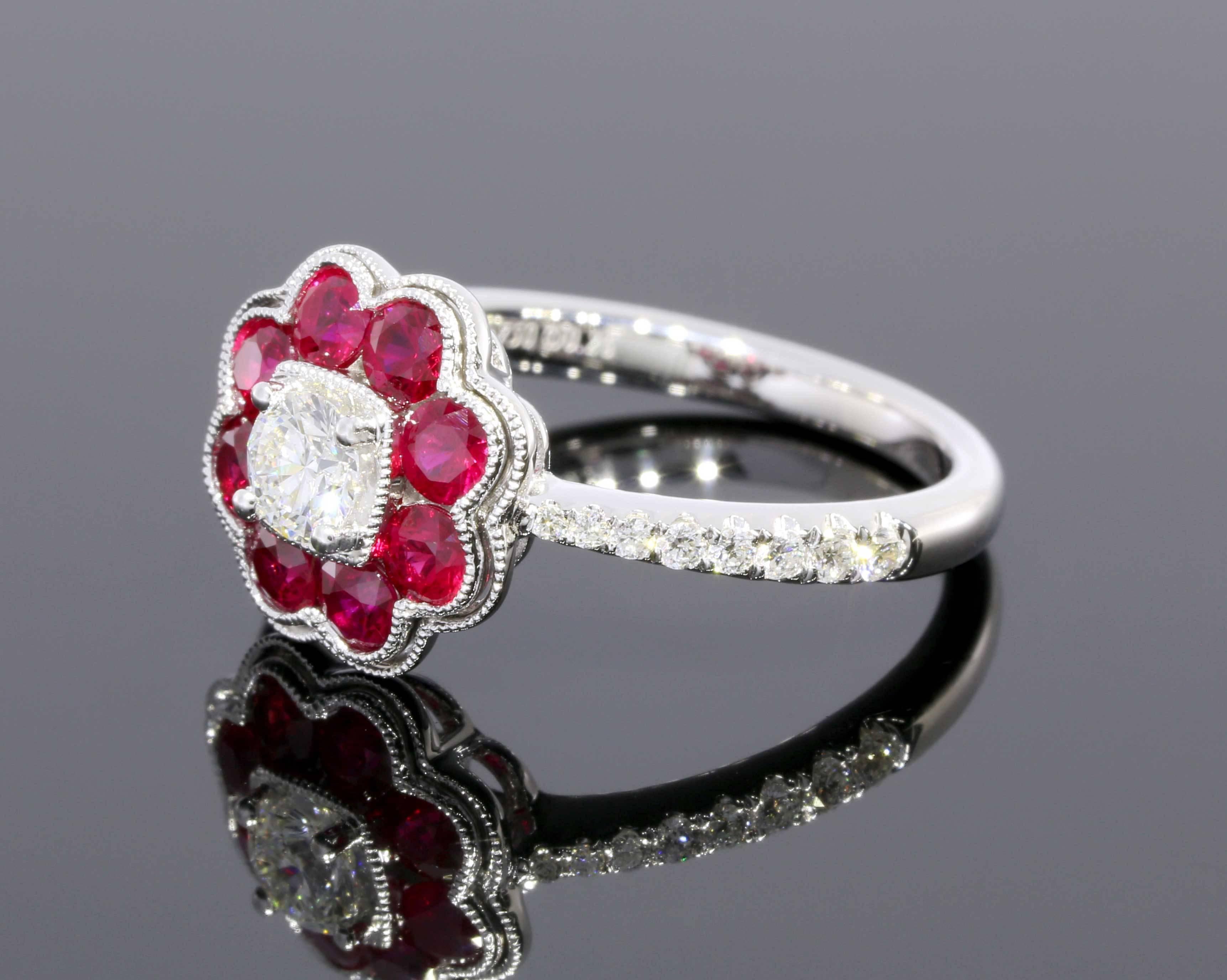 This mesmerizing ring features sparkly round brilliant cut diamonds & luscious natural rubies in a stunning halo flower ring design. The center diamond weighs .26 carat & is prong set. The richly colored rubies have a combined total weight of .87