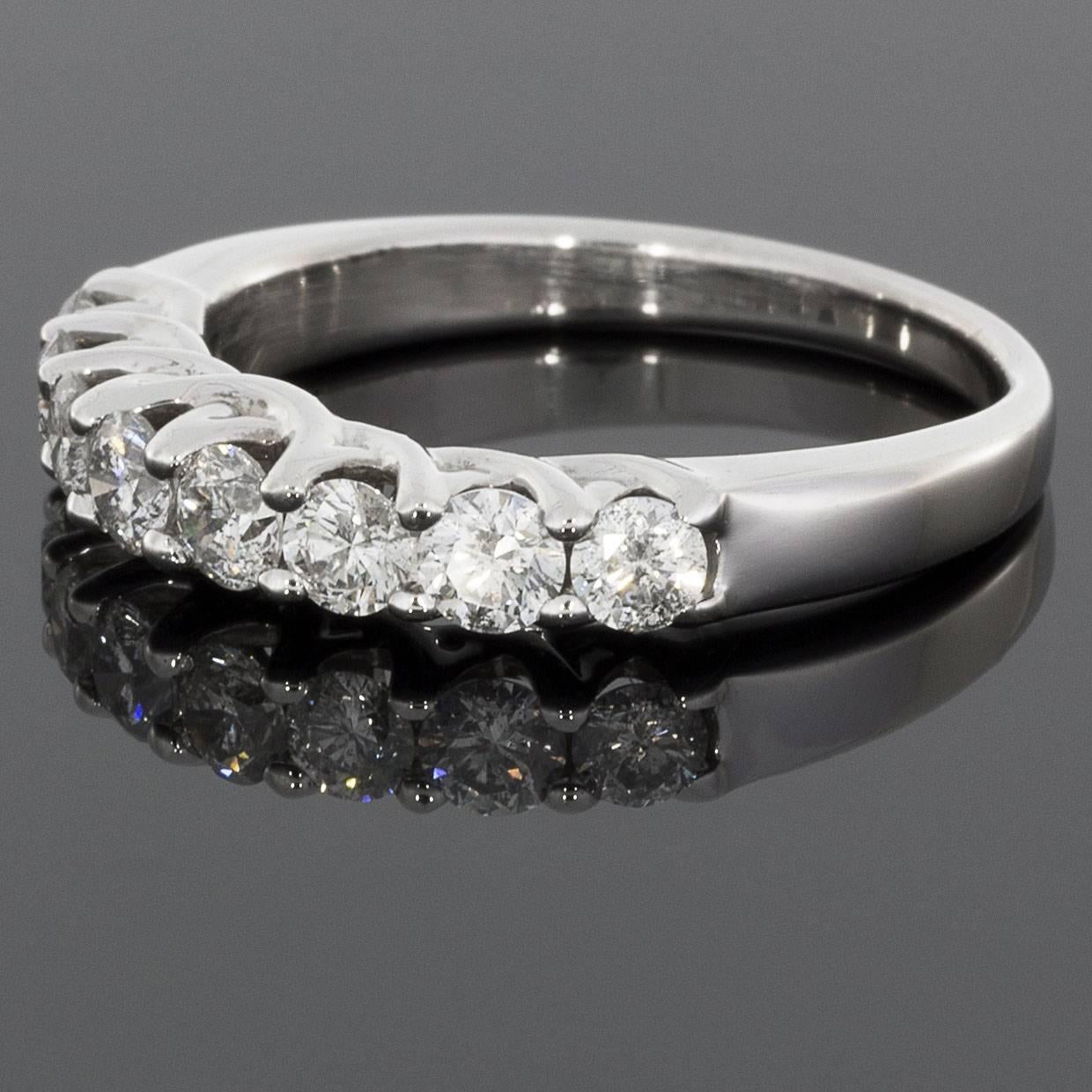 This classic diamond band would make a wonderful wedding band or anniversary ring. The ring is comprised of 14 karat white gold & features 8 round brilliant cut diamonds that have a combined total weight of 1.20 carats. The diamonds are HI/SI in
